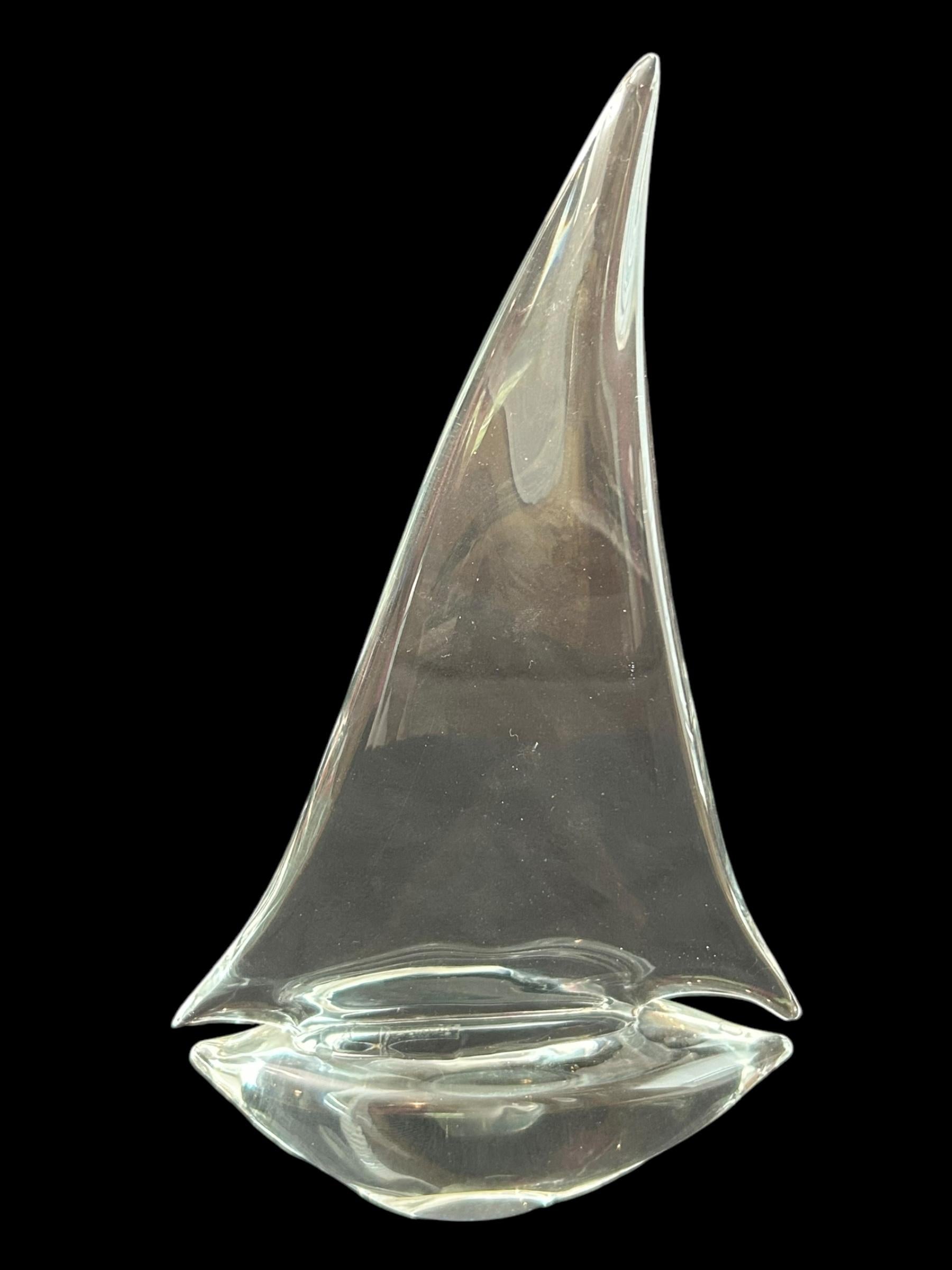 This vintage Murano glass sculpture features a beautiful sailboat design, crafted in Italy with clear glass materials.  The intricate details of the nautical theme make it a perfect addition to any collection or display.  Measuring approximately 15”
