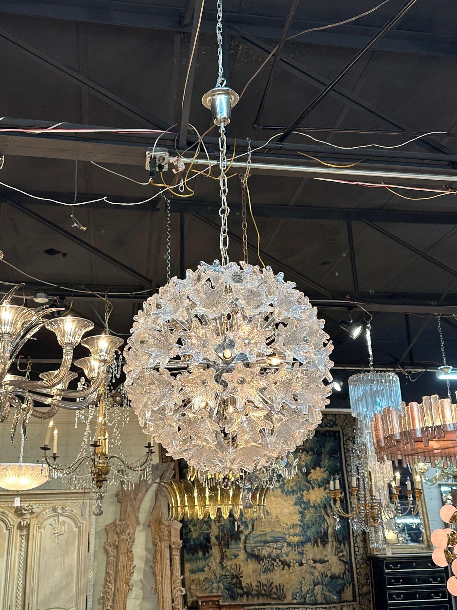 Gorgeous vintage Murano glass globe shaped Sputnik chandelier. Features beautiful Murano flowers. Creates a high-end designer look that is sure to impress!