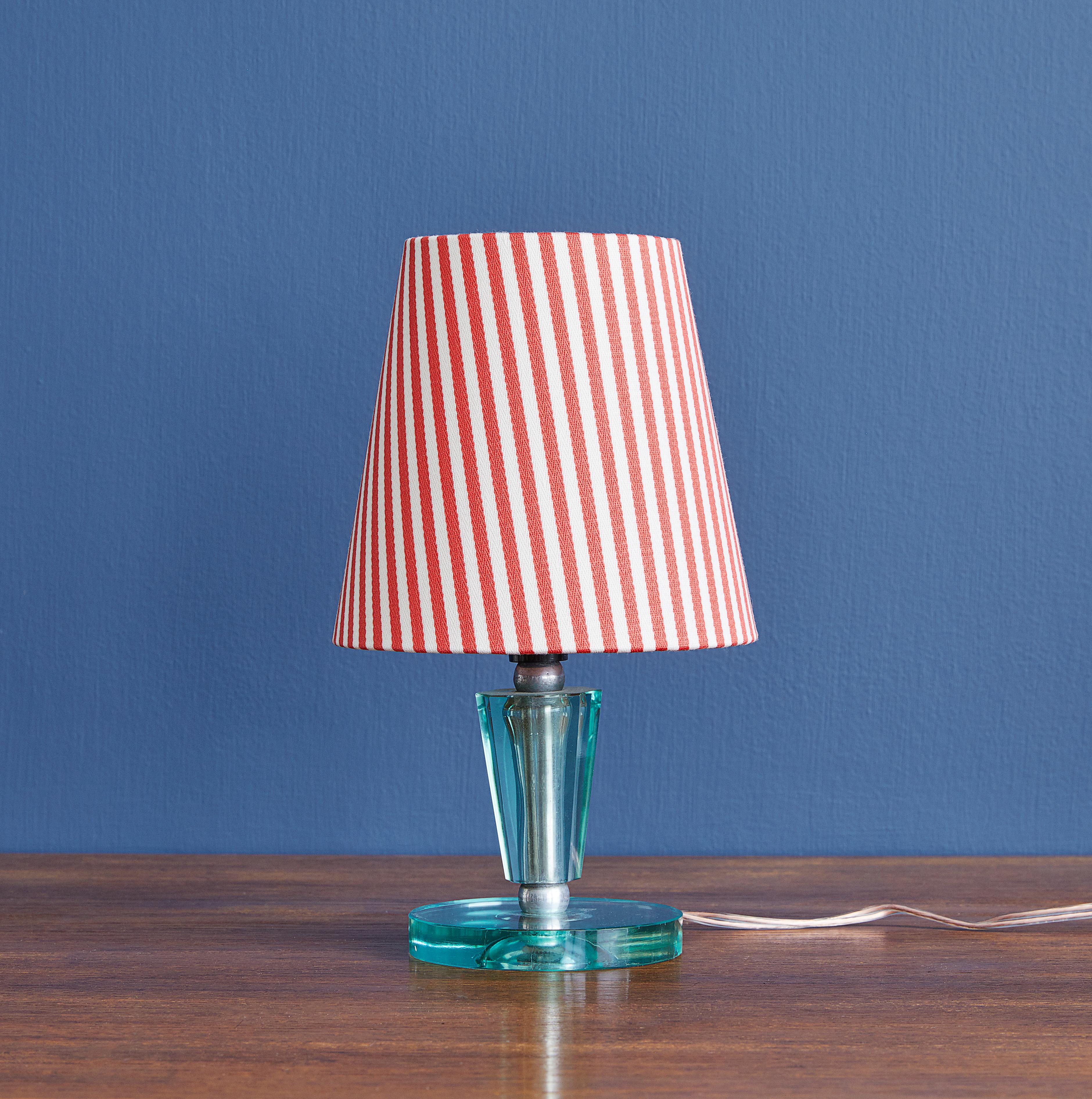 Vintage Italian table lamp in clear Murano glass with brass fittings. New linen shade with red stripes.