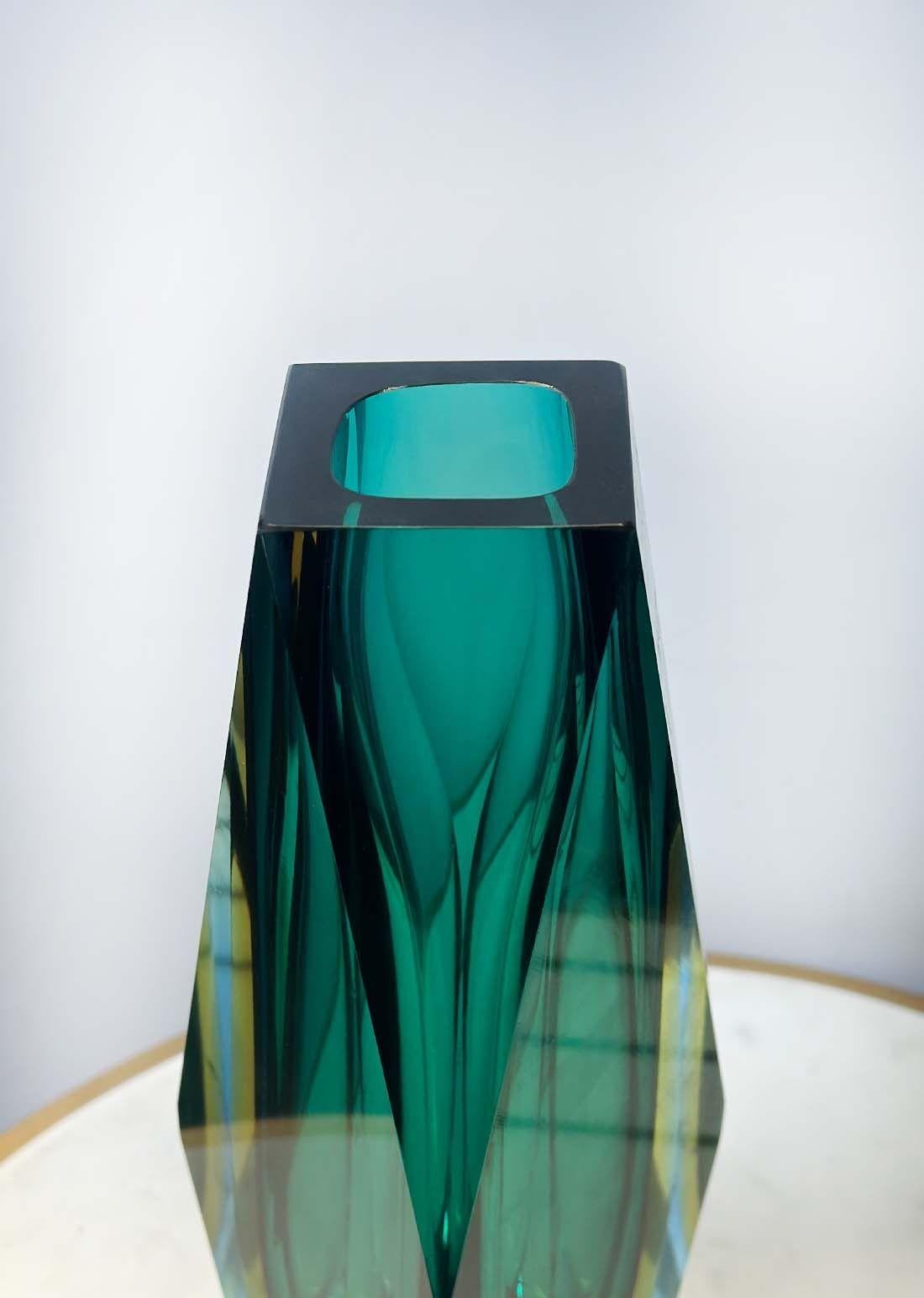 Single vintage vase with dominant turquoise blue, yellow and clear Murano glass, having a unique geometric body. Made in Italy, c. 1960's.
Dimensions:
12