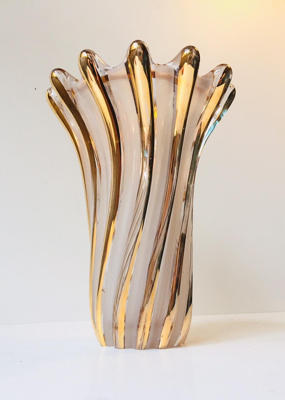 A twisted - fluted glass vase with applied gold glaze. Manufactured in Murano Italy during the 1960s probably by either Seguso or Barovier. Nice intact condition with a bit of typical ware to the base and some ware to the applied gold glaze.