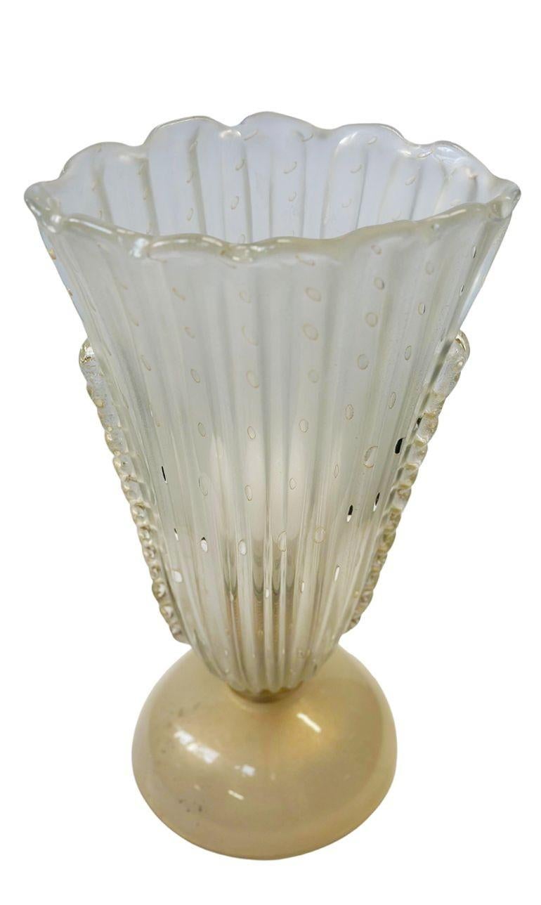 Single vintage Murano glass table lamp with gold fleck details all around the piece. This lamp is delicately hand-blown into a unique form that gives the illusion of a vase as well. Made in Italy, c. 1970's.
*Rewired to fit US lighting