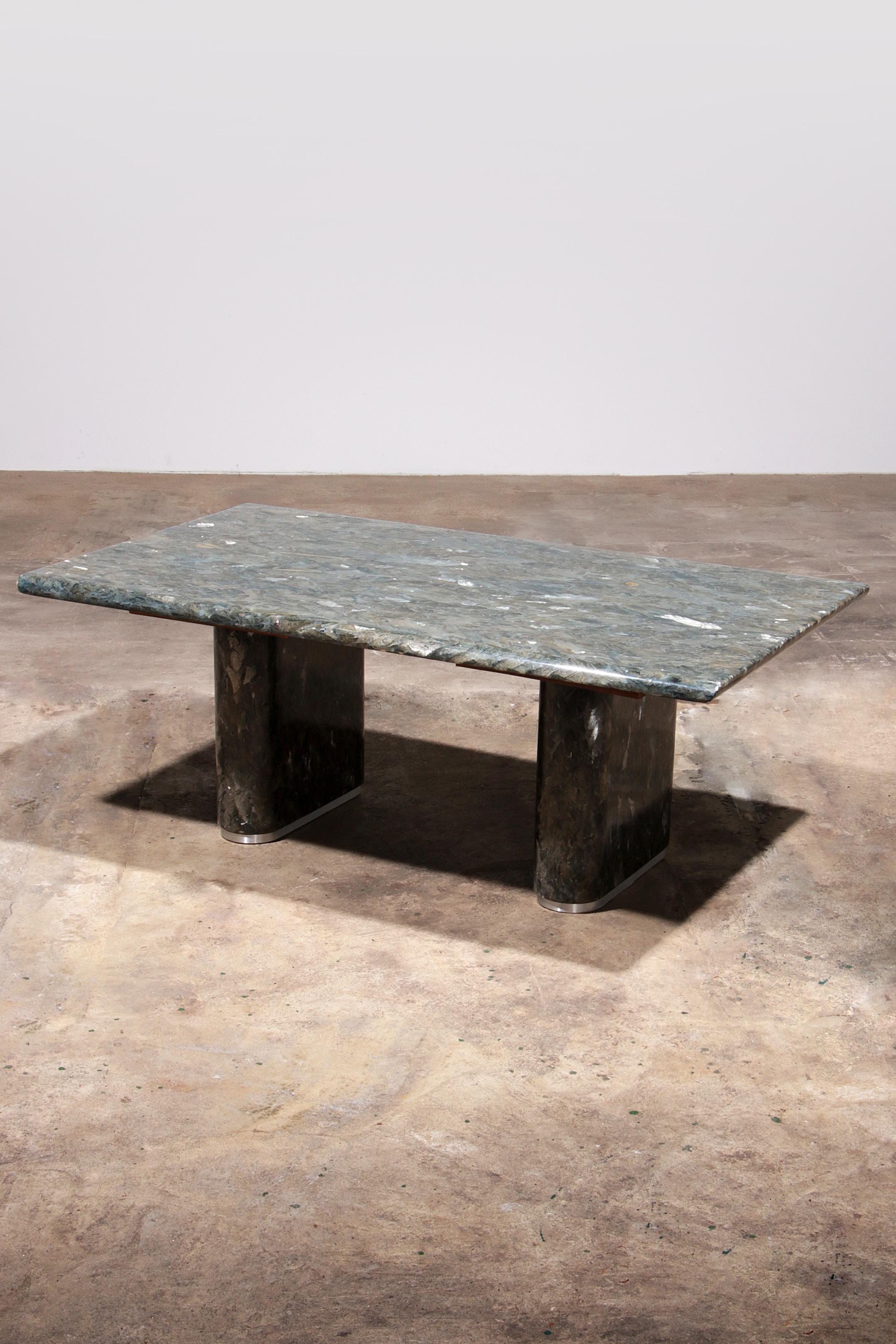 

Elevate your living space with this exquisite vintage natural stone coffee table, masterfully crafted in Italy. Featuring a unique veined natural stone  top in stunning shades of grey, beige, green, and mother-of-pearl, this table is a true