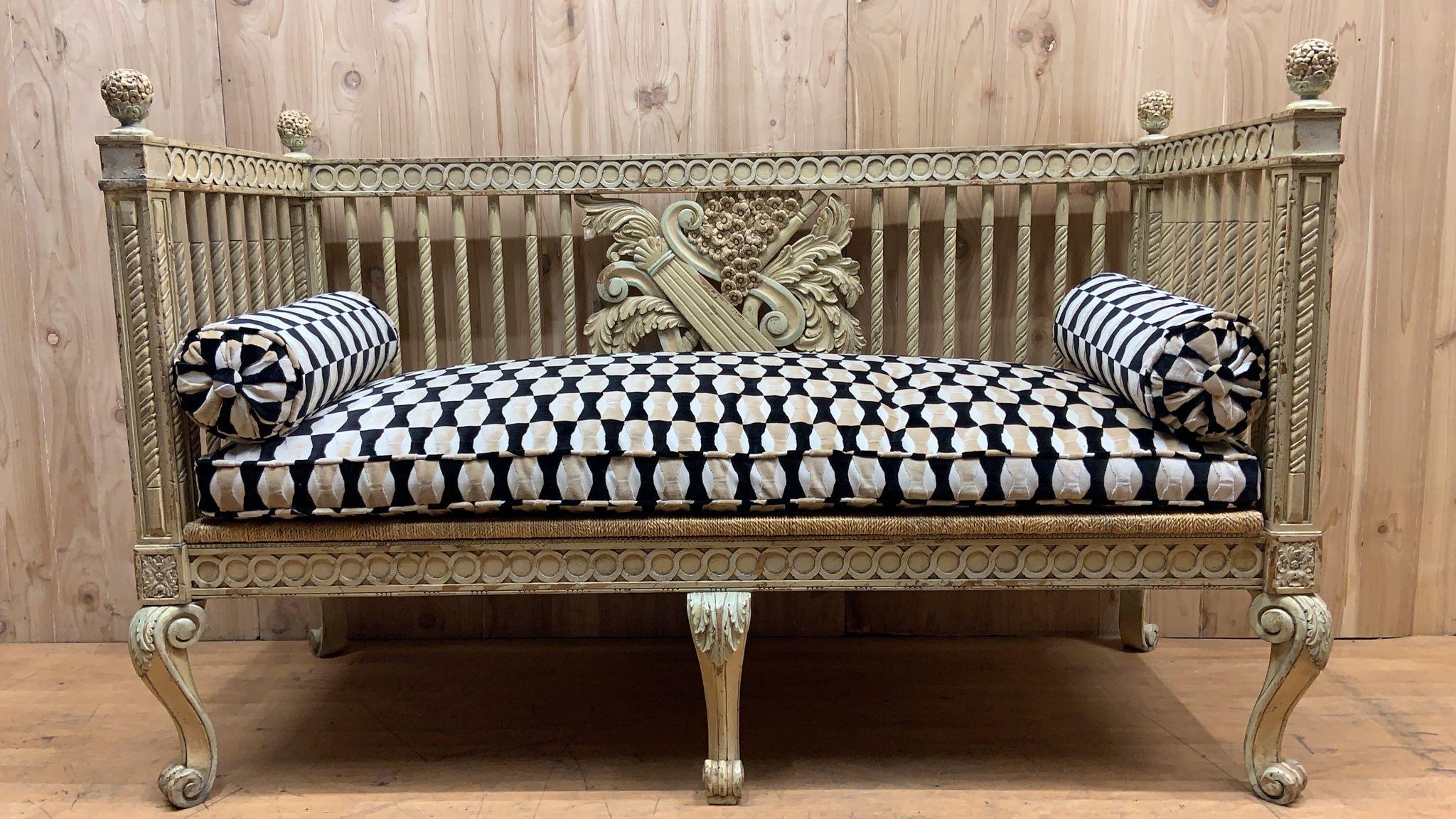 Vintage Italian Neoclassical Carved Settee Bench

Exquisite vintage Italian neoclassical painted settee. Stunning details include a carved musical motif of a lyre and trumpet on the front back and outside back, carved legs and finials. Large and