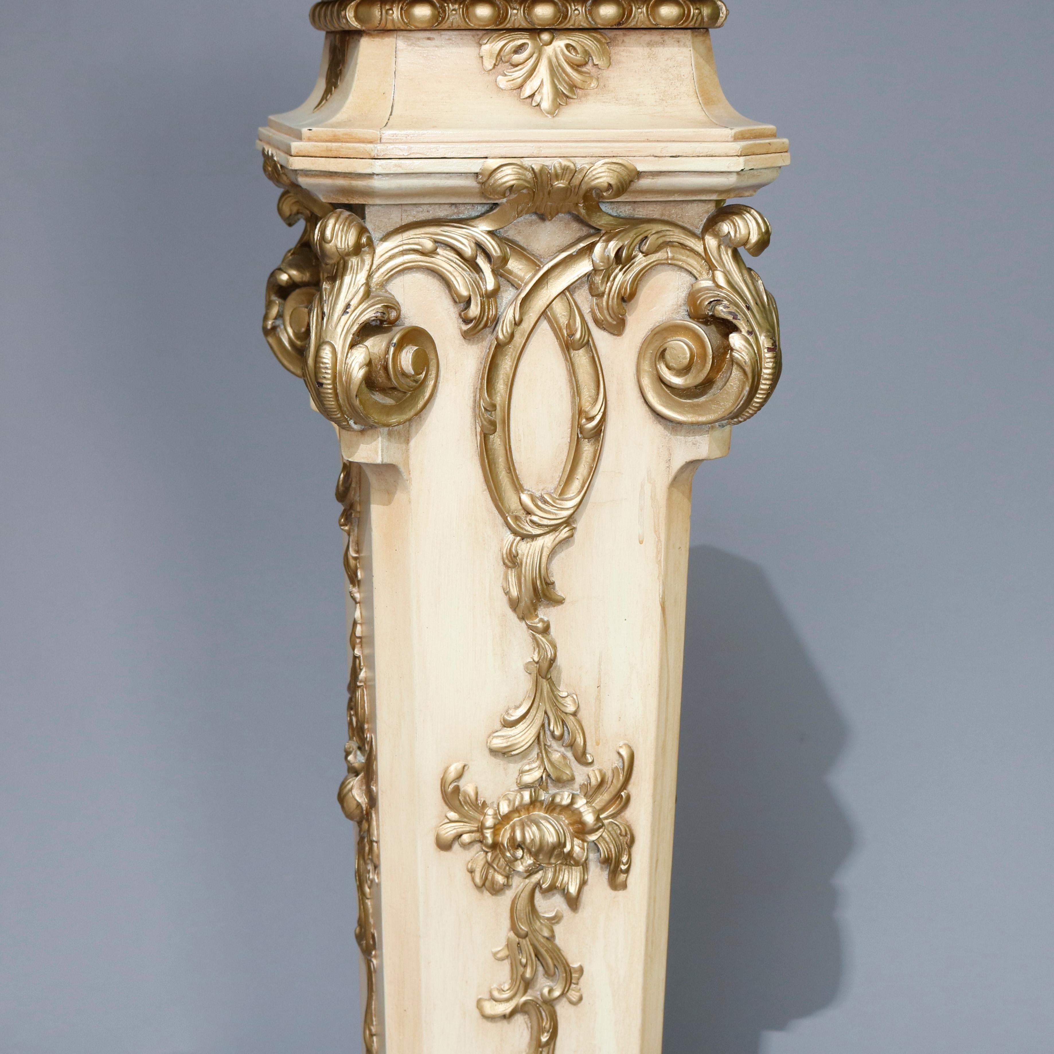 A vintage Italian neoclassical sculpture pedestal offers painted wood construction with tapered stylized Corinthian column-form with carved and gilt acanthus, scroll and foliate decoration surmounted by a clipped corner square marble display, 20th
