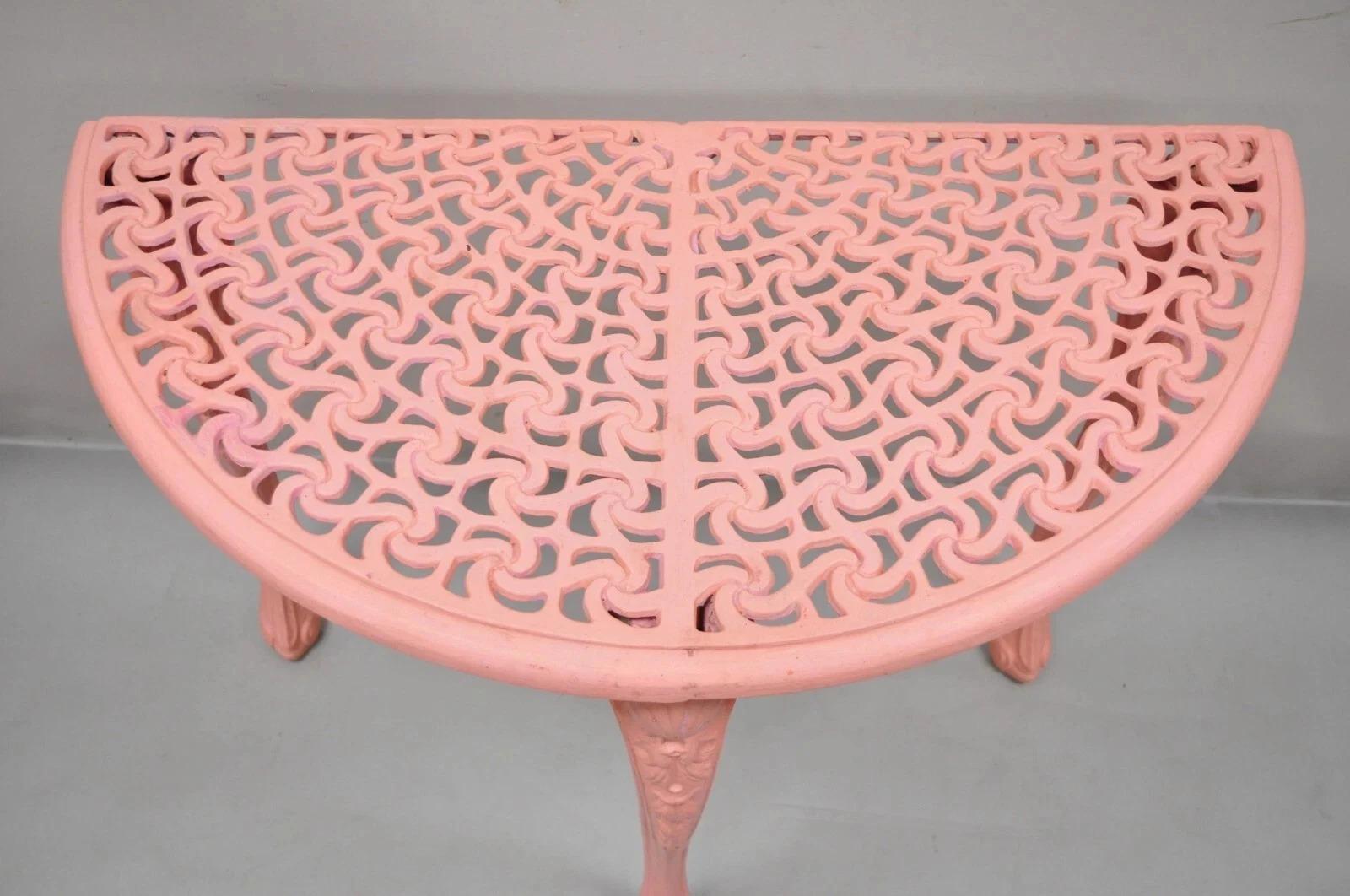 Please message us with your zip code to request a more reasonable domestic U.S. shipping quote.

Vintage Italian Neoclassical Style Cast Aluminum Pink Demilune Console Table. Item features a pierced decorated top, pink painted finish, cast aluminum
