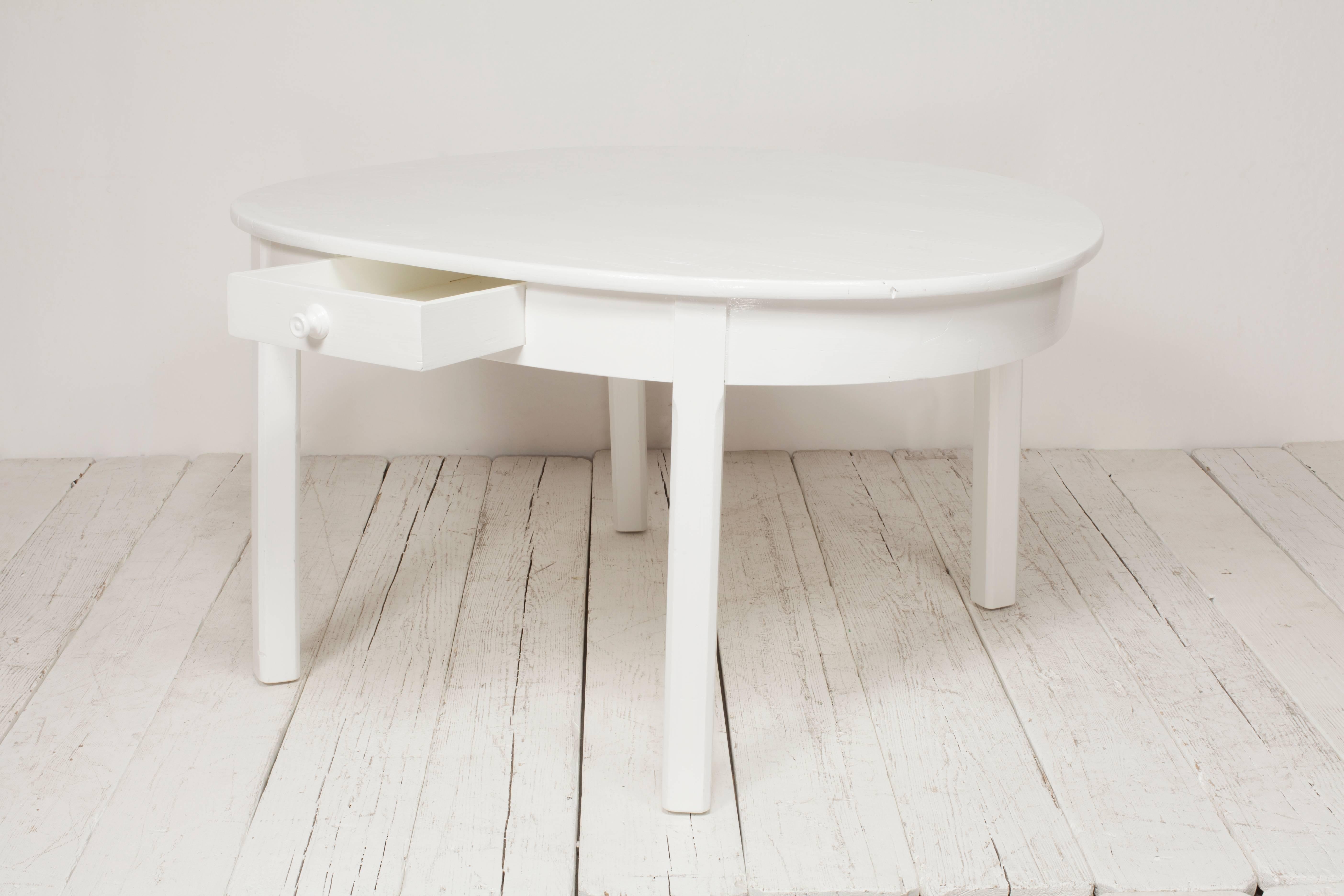 Vintage Italian newly white painted oval dining table with drawer.