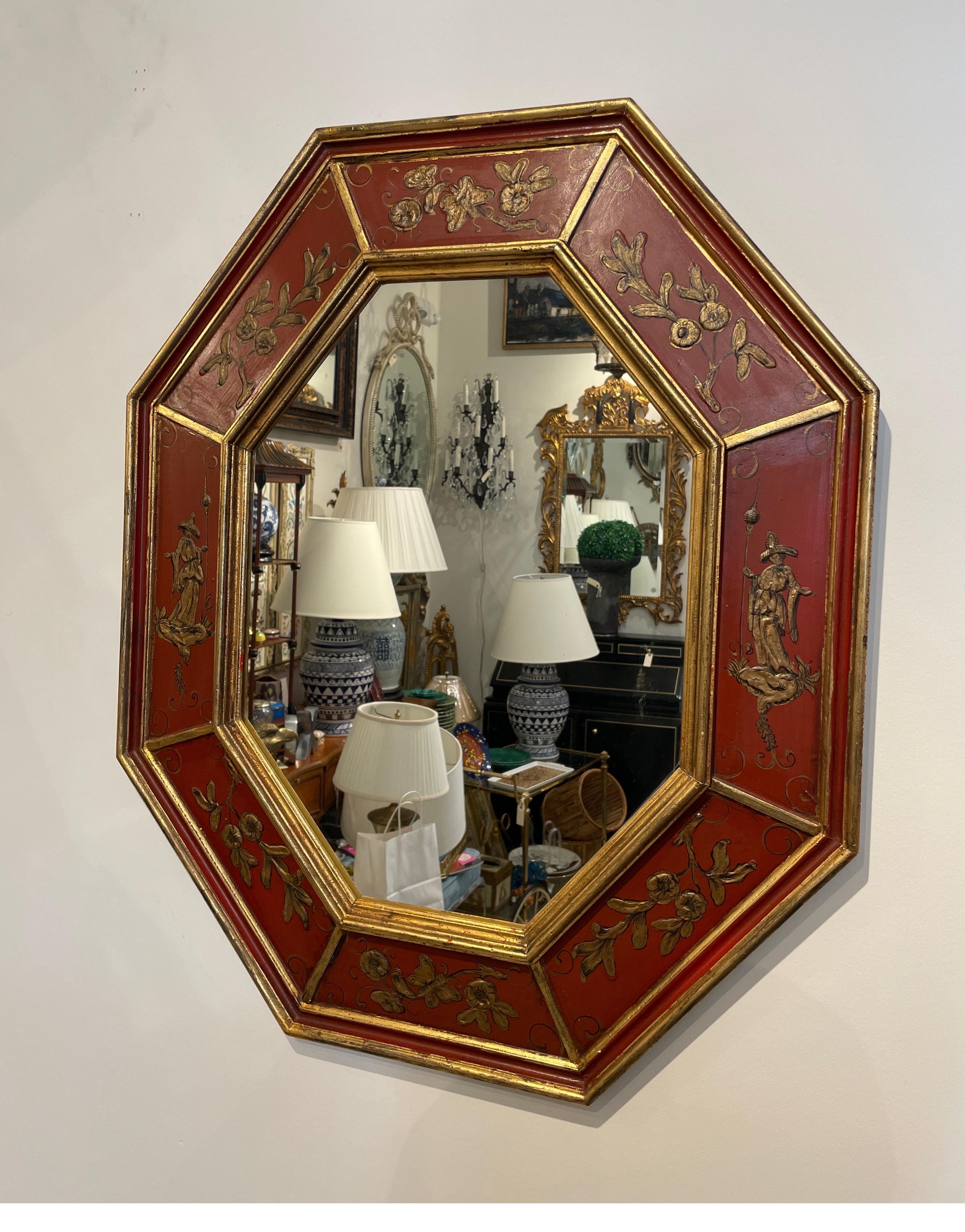 Vintage octagon shaped Italian gilded & painted Chinoiserie mirror. Finished in chinese red & gold. Each panel has a raised painted scene with flowers, butterflies & figures.