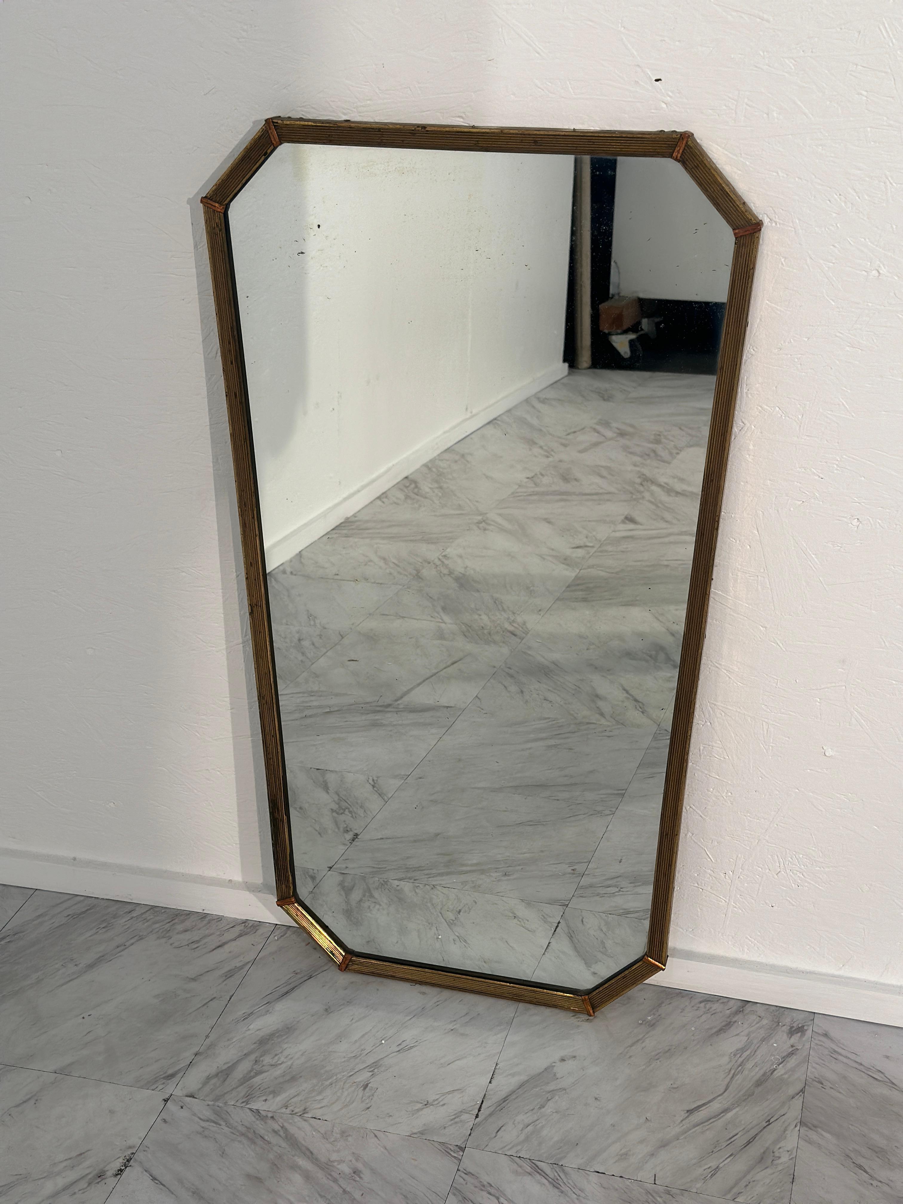 A chic 1970s Vintage Italian Octagonal  Brass Wall Mirror, showcasing sleek lines and timeless elegance in its brass frame, perfect for adding a touch of vintage sophistication to any room.

