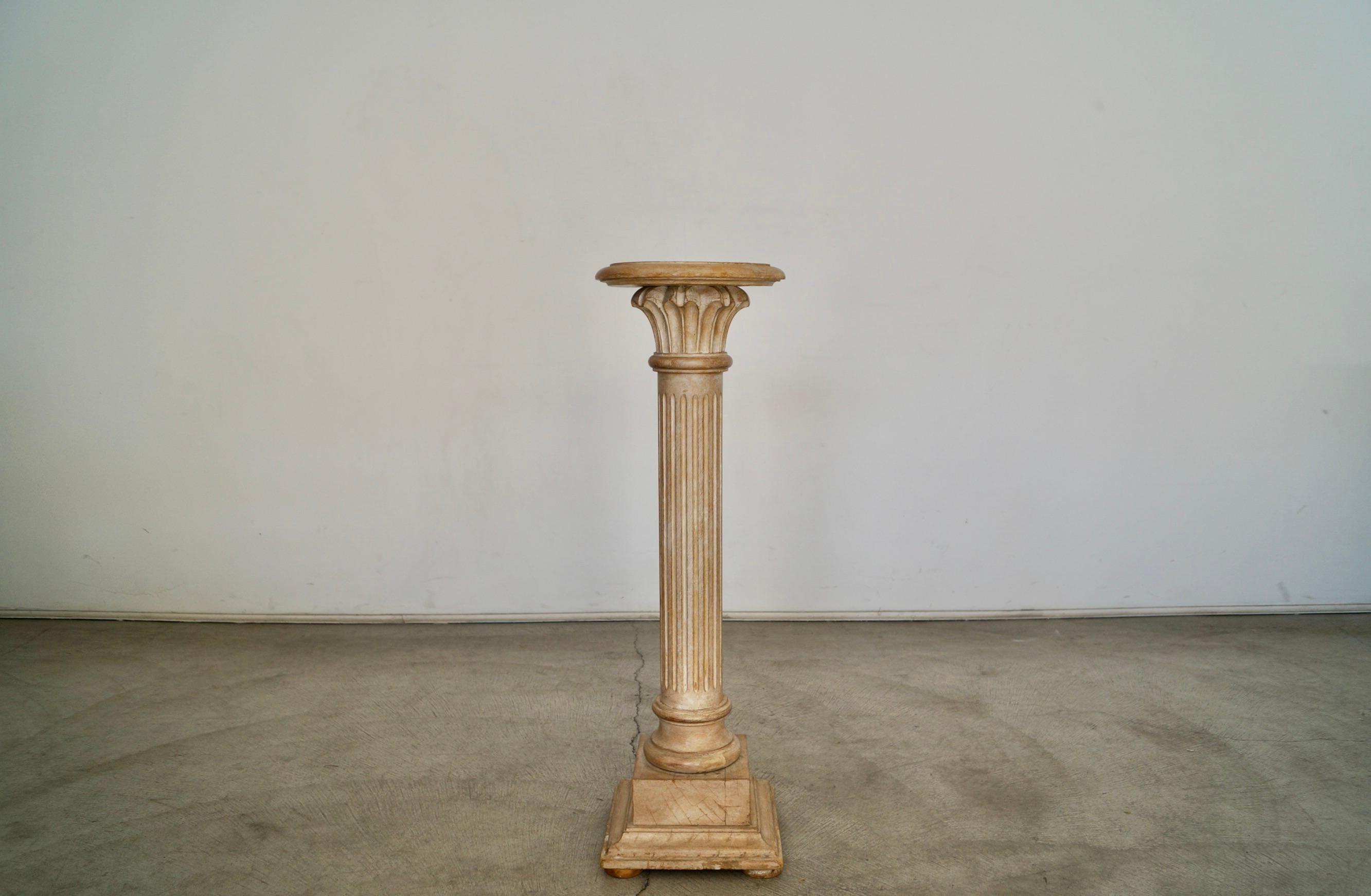 Vintage solid wood pedestal for sale. Made in Italy, and a beautiful Italian style and design. Looks like a Roman column, and has a beautiful aesthetic and finish. It’s washed in white over natural wood to give it a nice Old World finish. It’s in