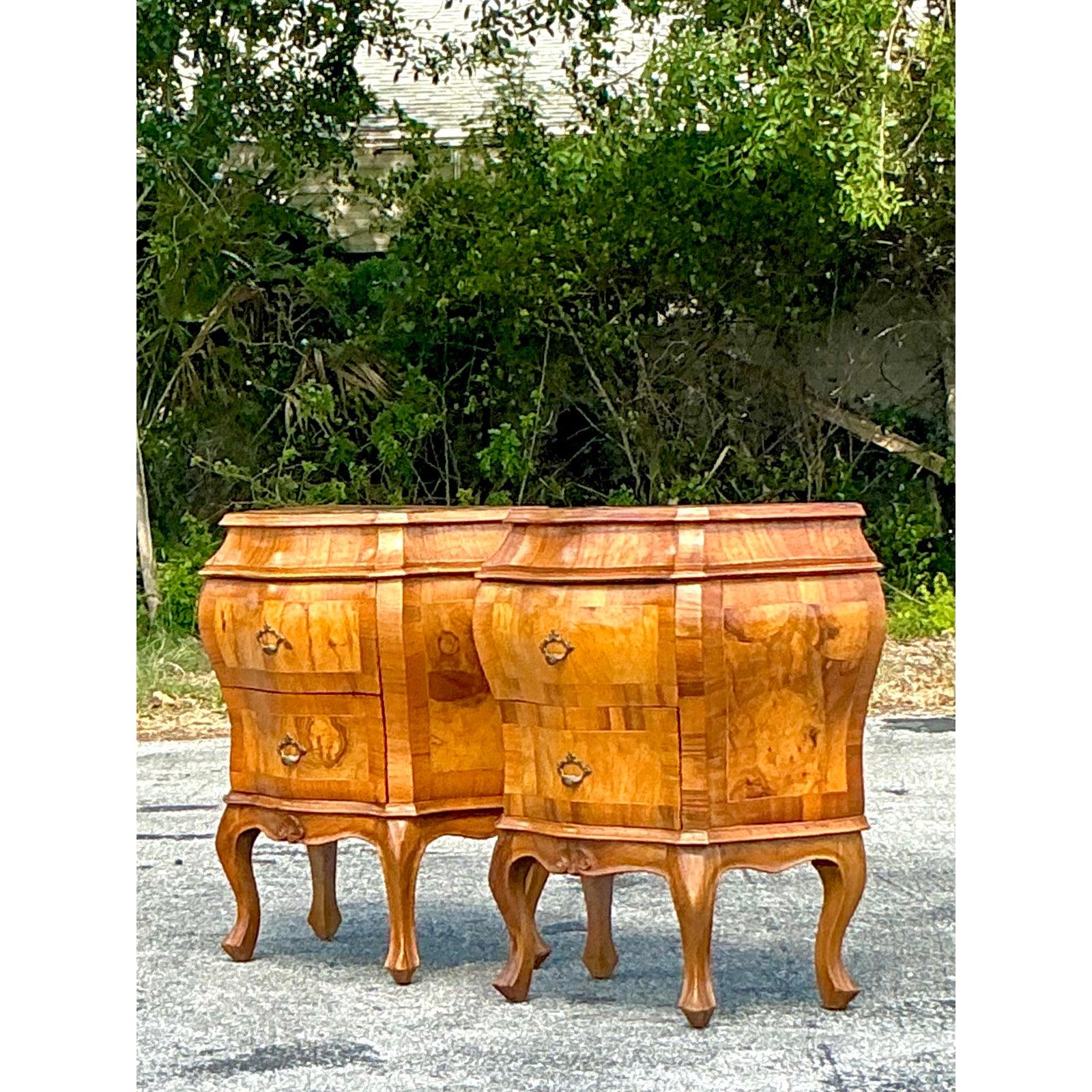 This exquisite pair of vintage olive burl wood nightstands adds a touch of timeless Italian elegance to your bedside. Crafted with meticulous detail, these nightstands showcase the rich, swirling patterns and warm tones of olive burl veneer, a