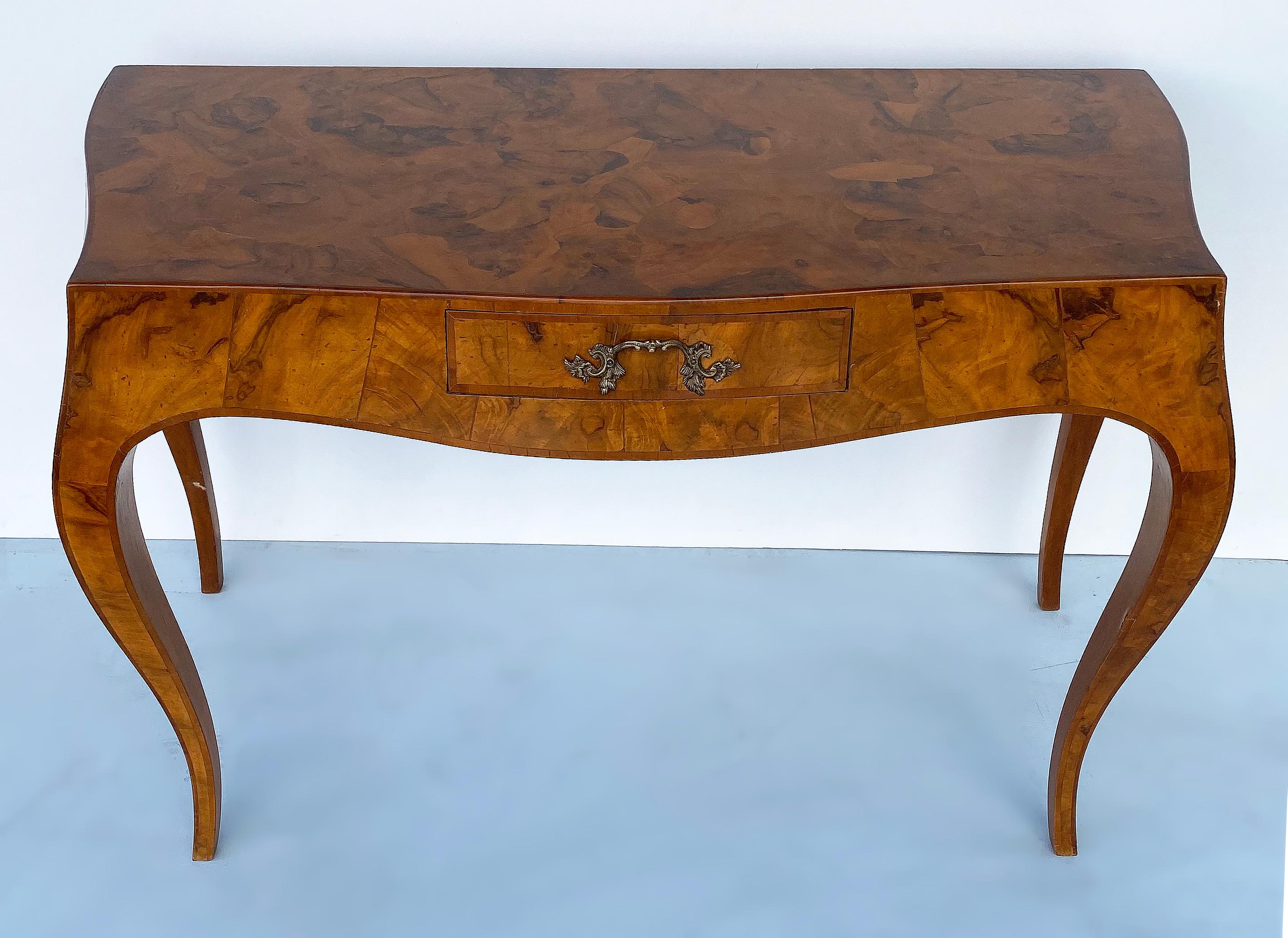 Vintage Italian olive wood writing desk.

Offered for sale is an elegant Italian olive wood desk with a single drawer. Beautifully grained wood with curved splayed legs. The desk is wrapped in a patchwork of fitted olive wood patterned pieces