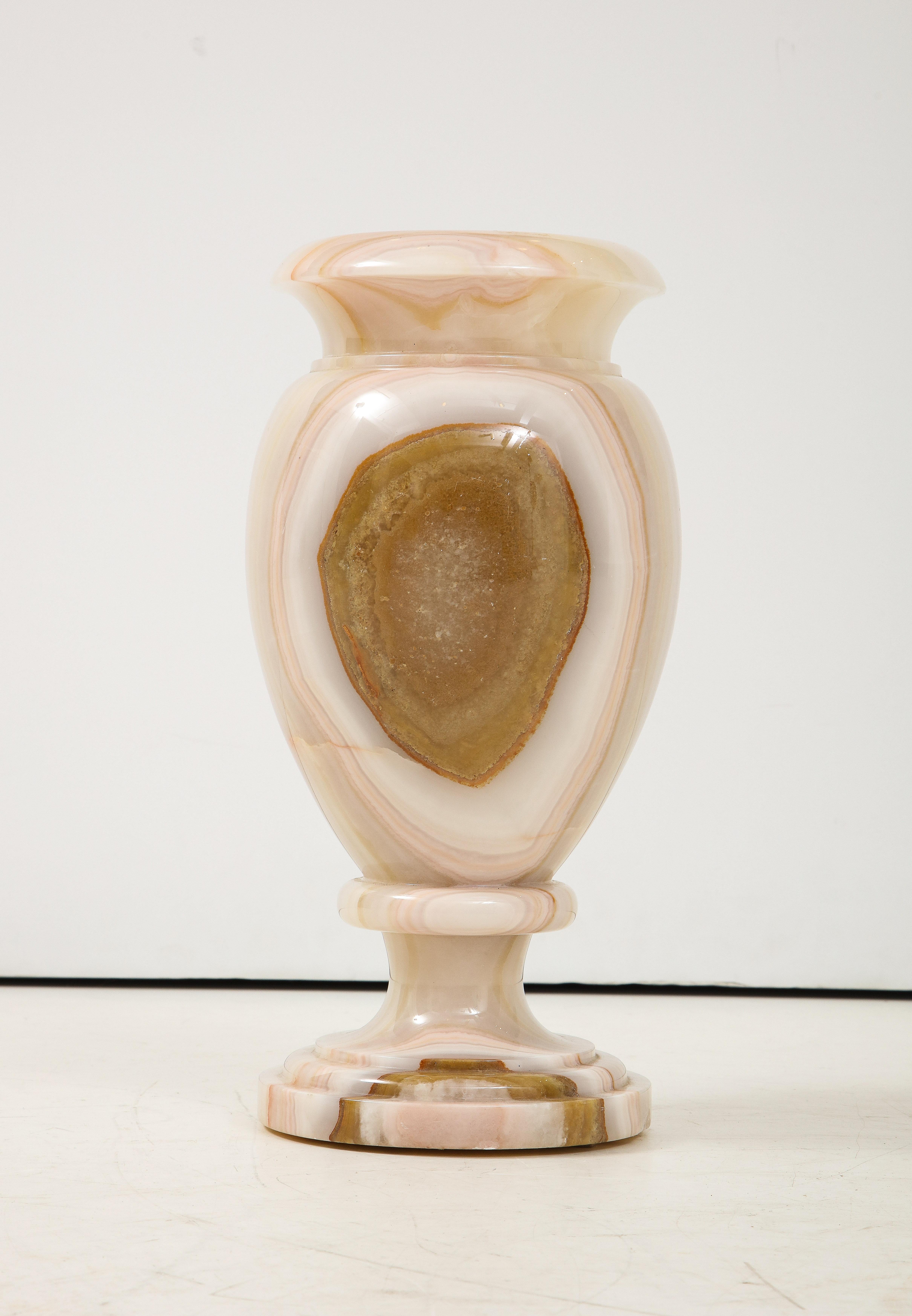 A large Italian onyx baluster form vase with beautiful central design; organic in design displaying the natural beauty of the stone and neutral coloration. Of very heavy weight; approximately 40-50 lbs.
Italy, circa 1950 
Size: 16