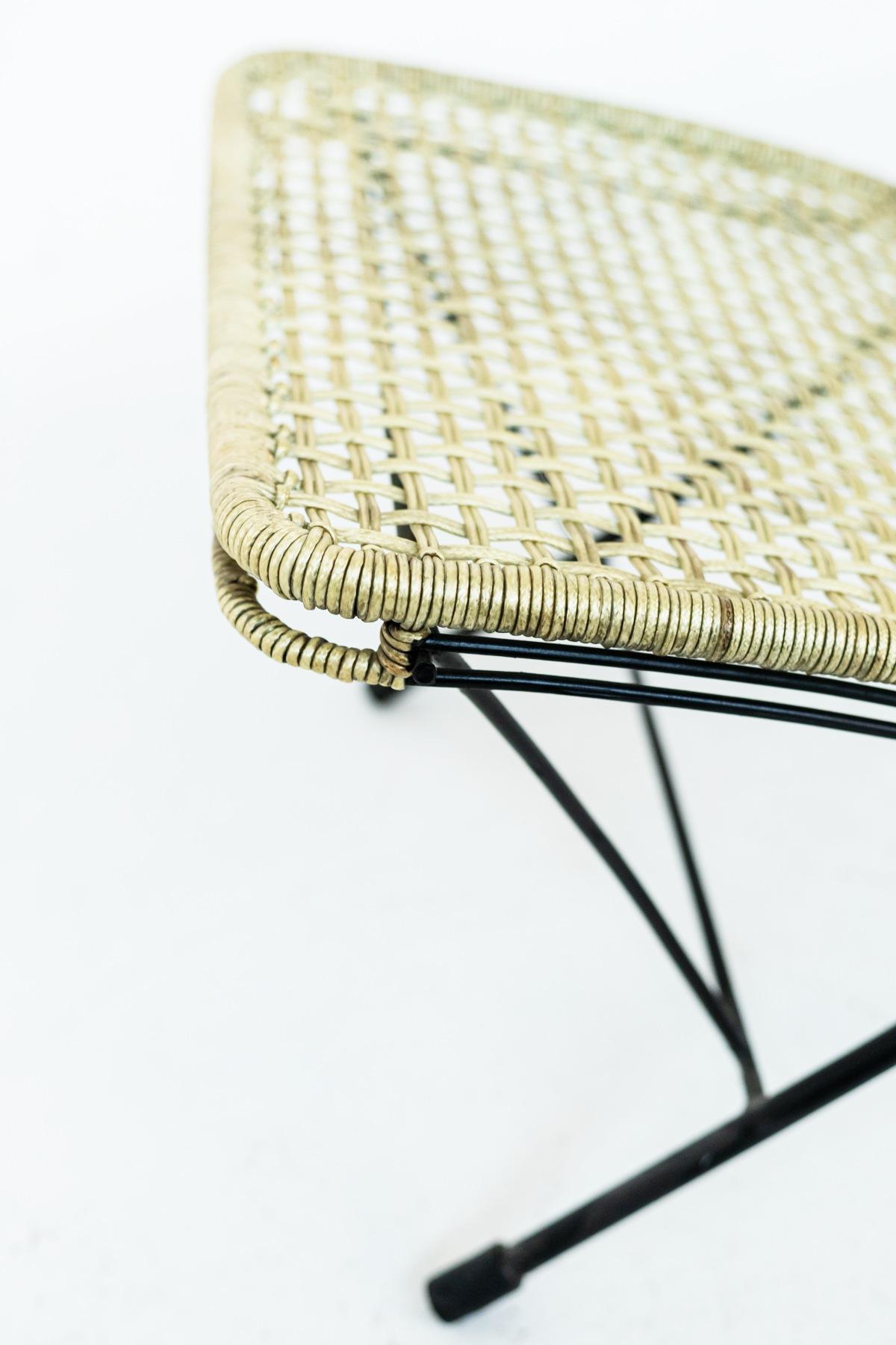 The pair of vintage outdoor chairs are from the 50s and of fine Italian manufacture. 
The structure is made of iron with woven plastic rope to make up the seat and back-rest. The chairs are very beautiful with their elegantly curved legs and