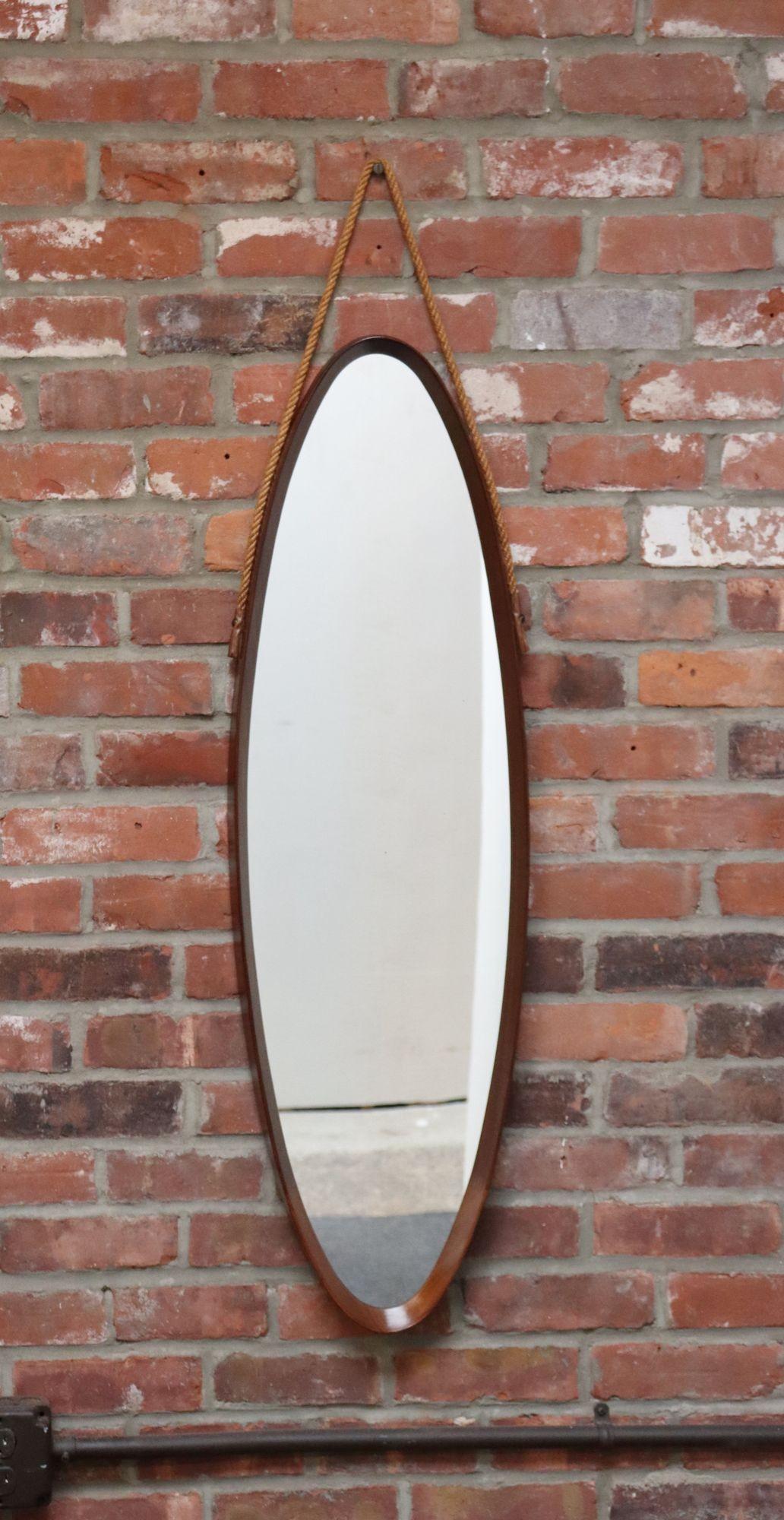 Specchio ovale da parete in noce italiano di metà secolo con cinghia in corda (1960 circa, Italia).
Telaio in noce curvato e profondamente scolpito con dettagli di falegnameria di grande effetto.
Il vetro presenta una leggera patina e un piccolo