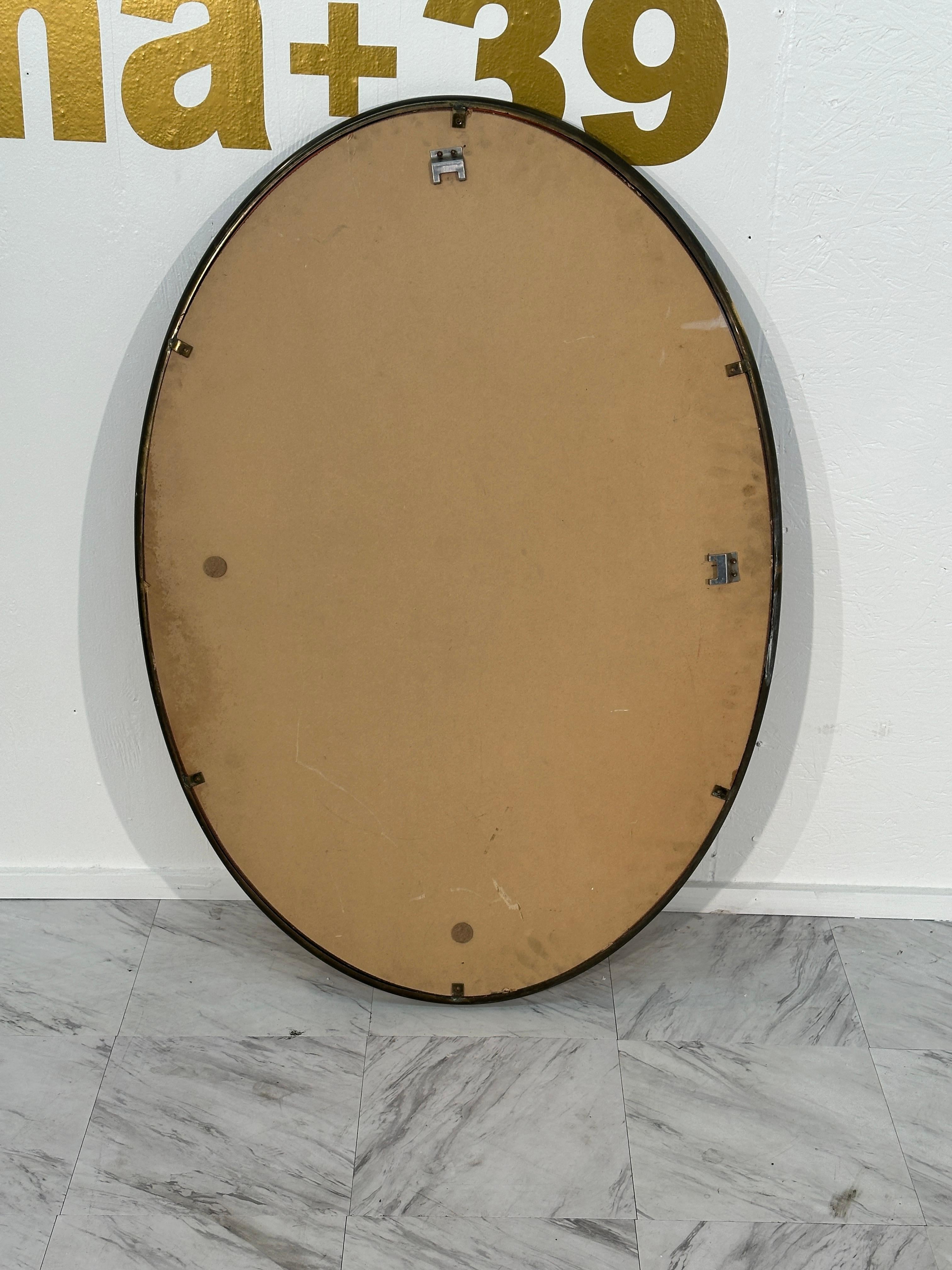 The Vintage Italian Oval Wood Wall Mirror with Smoked Glass from the 1980s is a sleek and sophisticated piece. Its oval shape and smoked glass infuse a touch of retro elegance into any space. Crafted with Italian finesse, this mirror combines