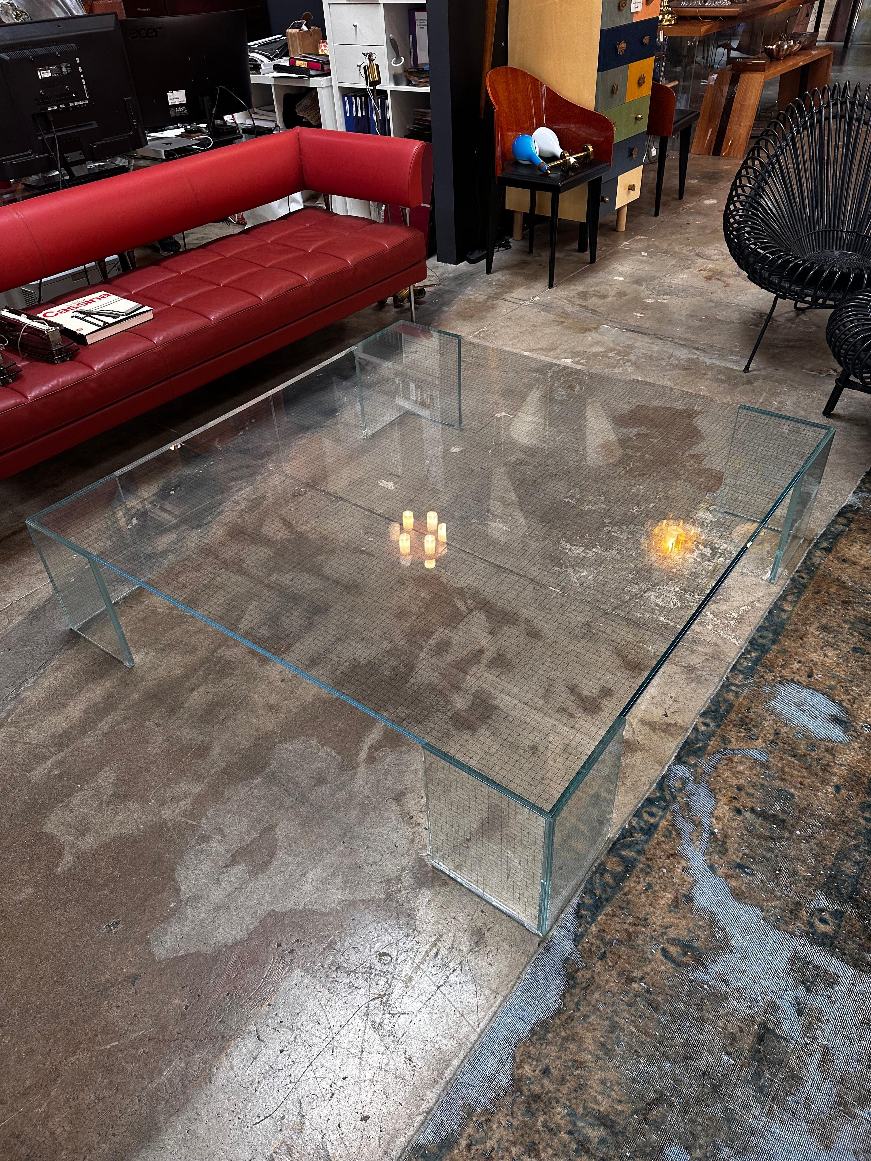 he Vintage Italian Oversize Full Glass Coffee Table by Glas Italia is a striking blend of functionality and artistry. Crafted with finesse, the table features a seamless expanse of glass that creates an illusion of space and light in any room. Its