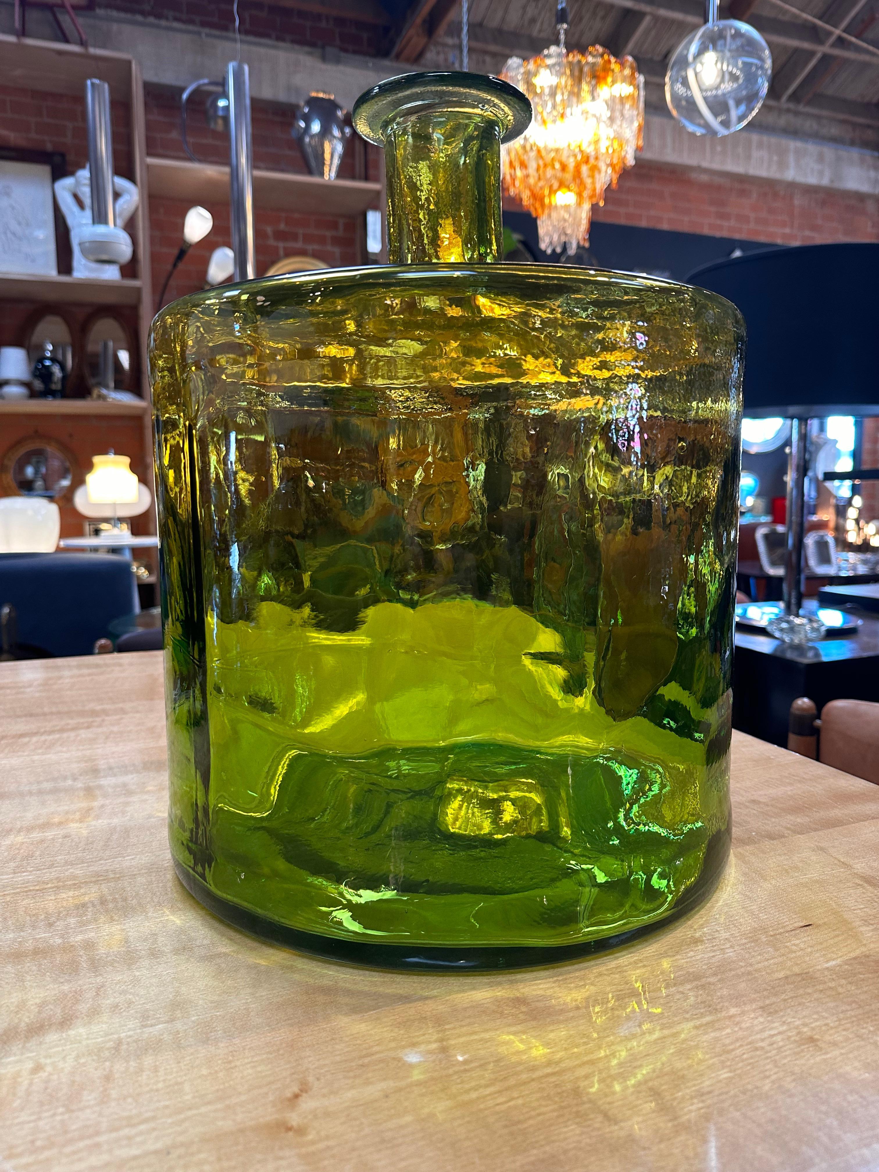 Introduce a touch of vintage elegance with our Oversize Murano Green Vase from the 1980s. Handmade in Italy, this unique piece captivates with its distinct color and shape, showcasing the artistry of Murano glass craftsmanship. A stunning statement