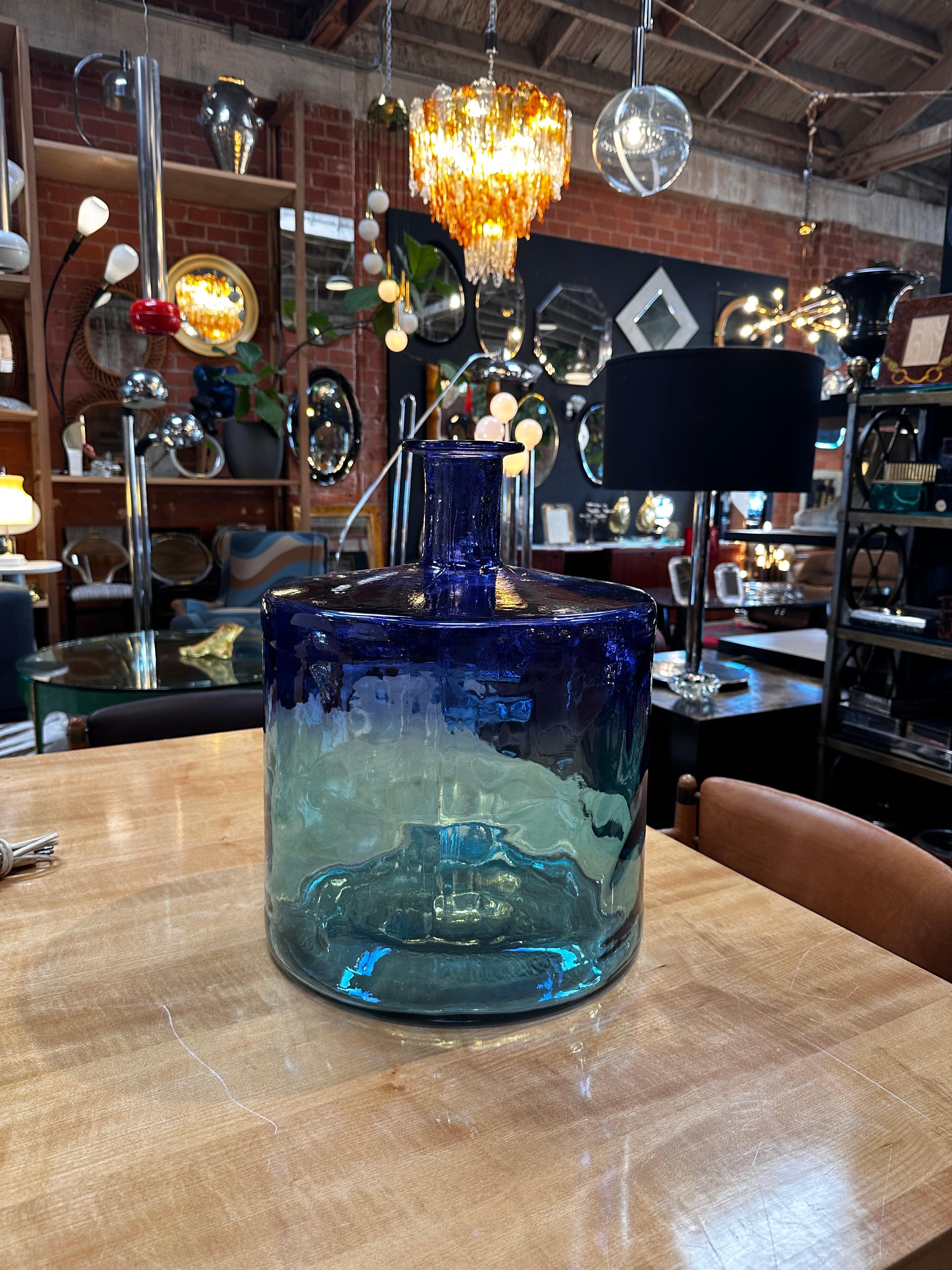 Introduce a touch of vintage elegance with our Oversize Murano Blue Vase from the 1980s. Handmade in Italy, this unique piece captivates with its distinct color and shape, showcasing the artistry of Murano glass craftsmanship. A stunning statement