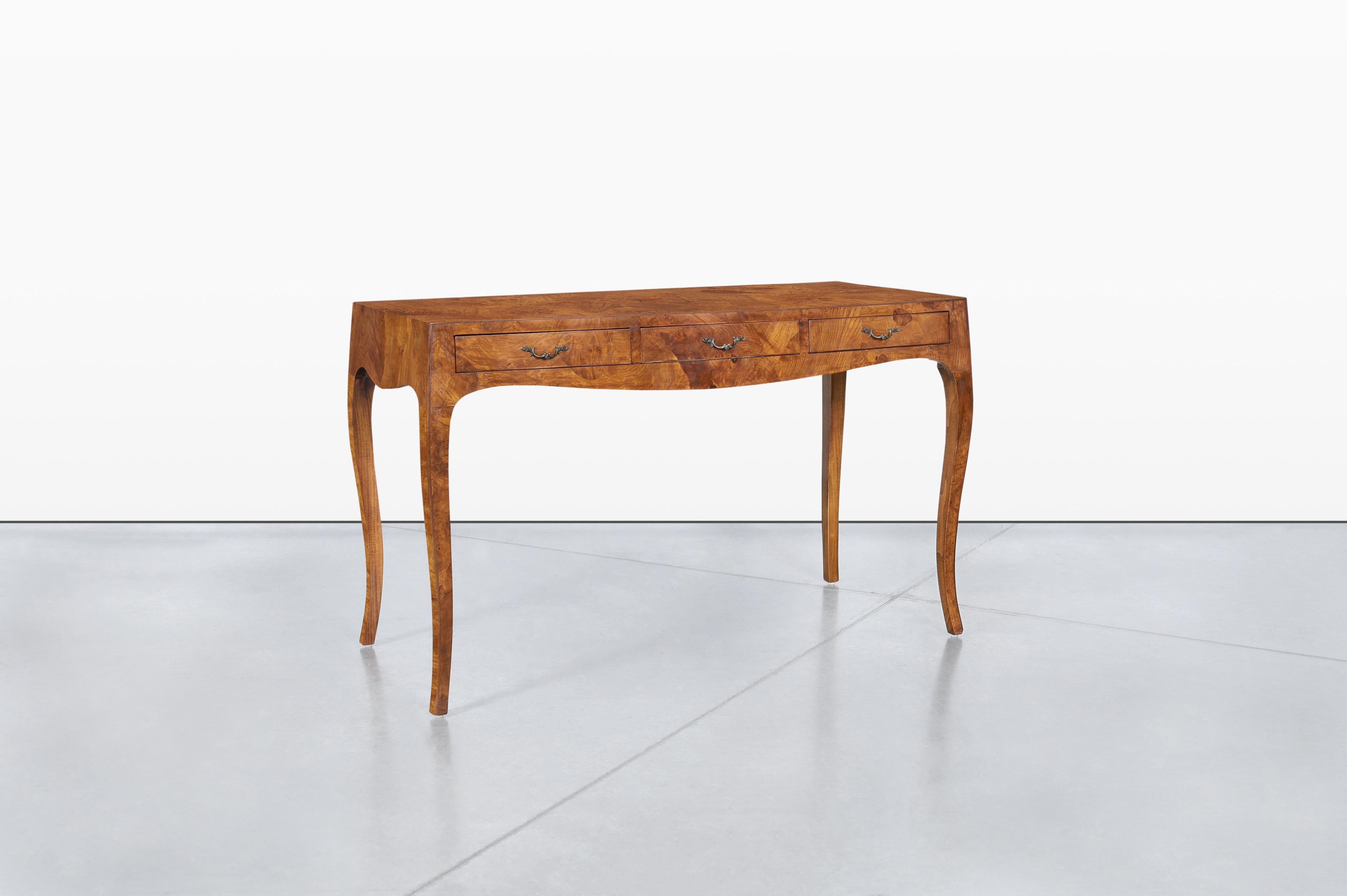 Discover the charm of vintage elegance with this exquisite Italian writing desk, a stunning piece that combines functionality with timeless design. Crafted from rich oyster olive burl wood, the desk showcases a beautiful pattern that adds a touch of