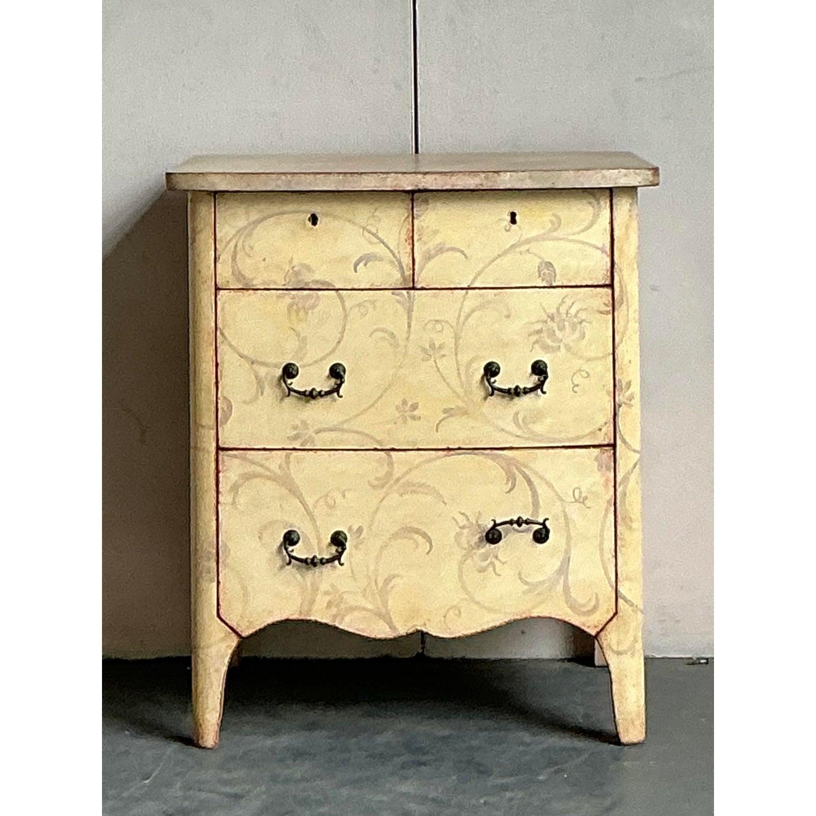 Elevate your interior with this charming vintage Italian chest, a testament to enduring Neoclassical design. This exquisite piece showcases delicate hand-painted floral and scroll motifs over a beautifully aged patina finish, evoking the rustic