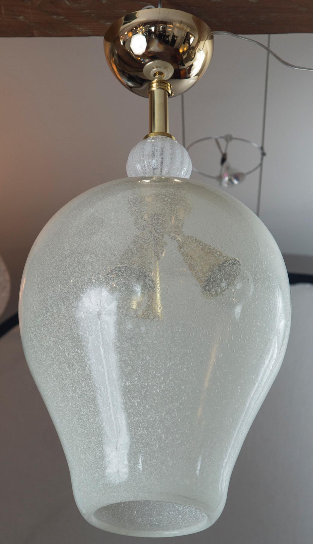 This pulegoso technique of glass blowing, is a manner of blowing in which the glass is densely filled with tiny bubbles offering a uniquely textured and warm illumination.
We have made this vintage glass install ready with a new solid brass deep