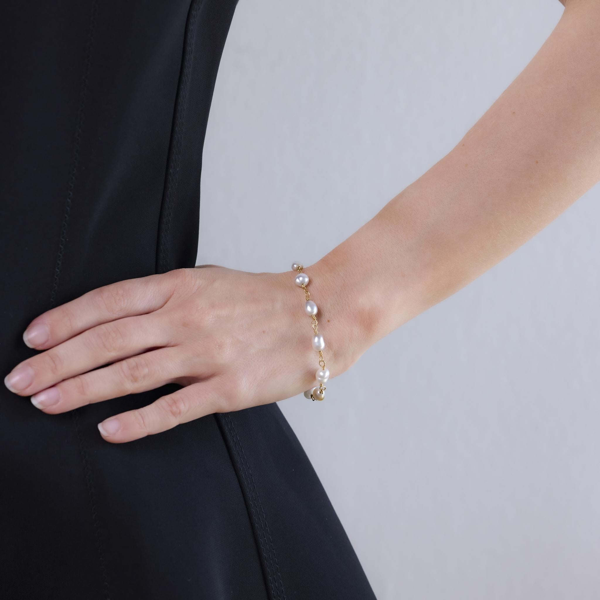 This vintage bracelet from the 1980s is crafted in 14k yellow gold and features ten cultured pearls ranging in size from approximately 10.60mm to 5.64mm. The elegant gradient design is complemented by Italian craftsmanship and is hallmarked with