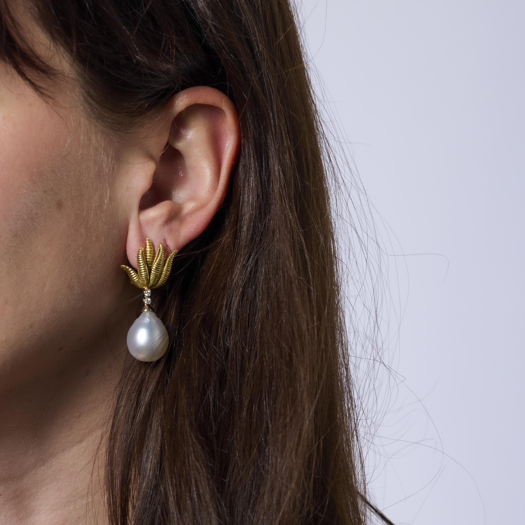 These bold vintage earrings feature two luminous pearls accented by sparkling diamonds, set in rich 18k yellow gold. A glamorous 1980s design that blends classic elegance with statement-making style.