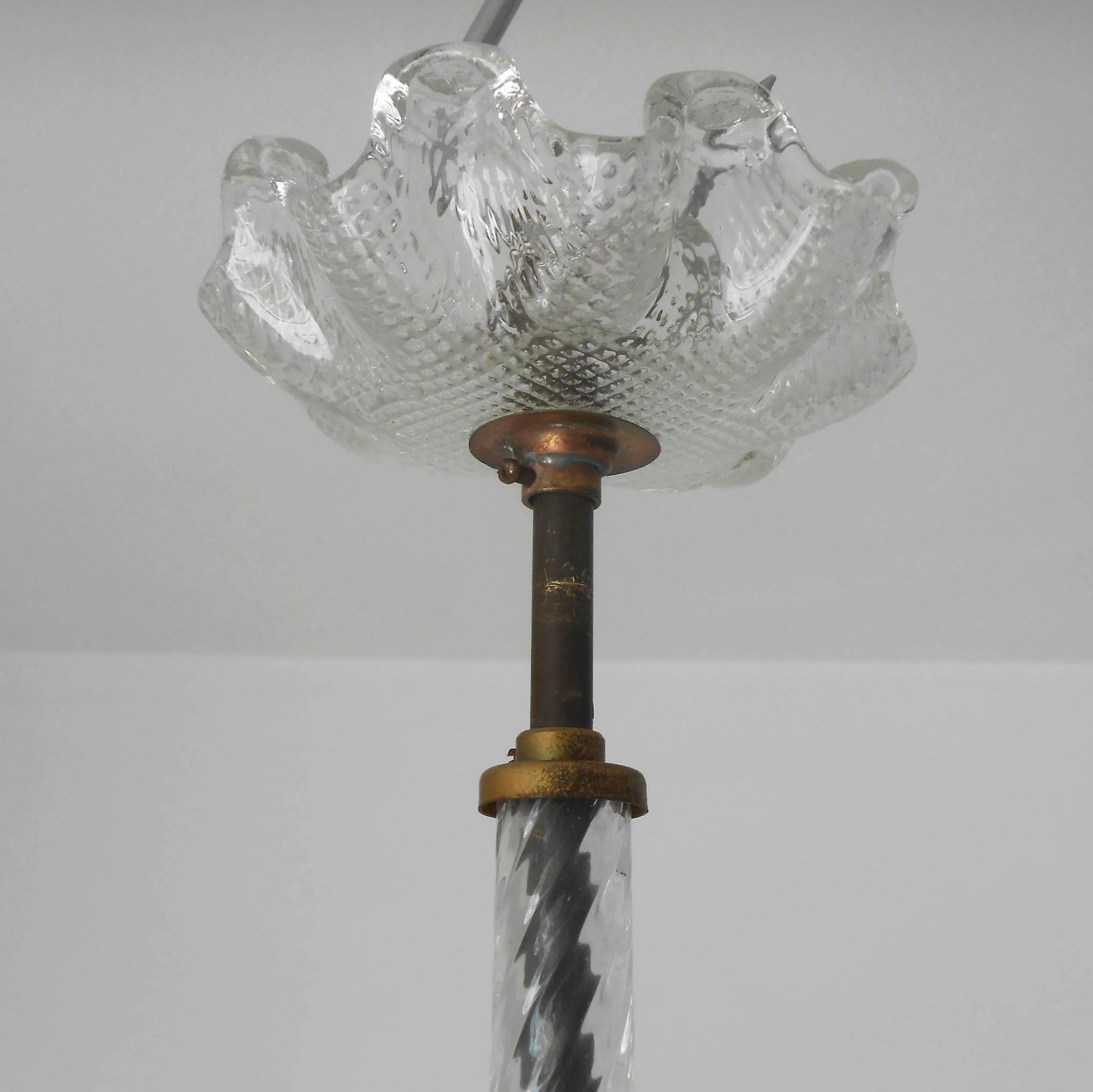 Vintage Italian pendant chandelier with textured clear Murano glass hand blown into a fountain shaped cup surrounded by twisted glass, glass rod and canopy, mounted on brass hardware / Designed by Ercole Barovier circa 1950s / Made in Italy.