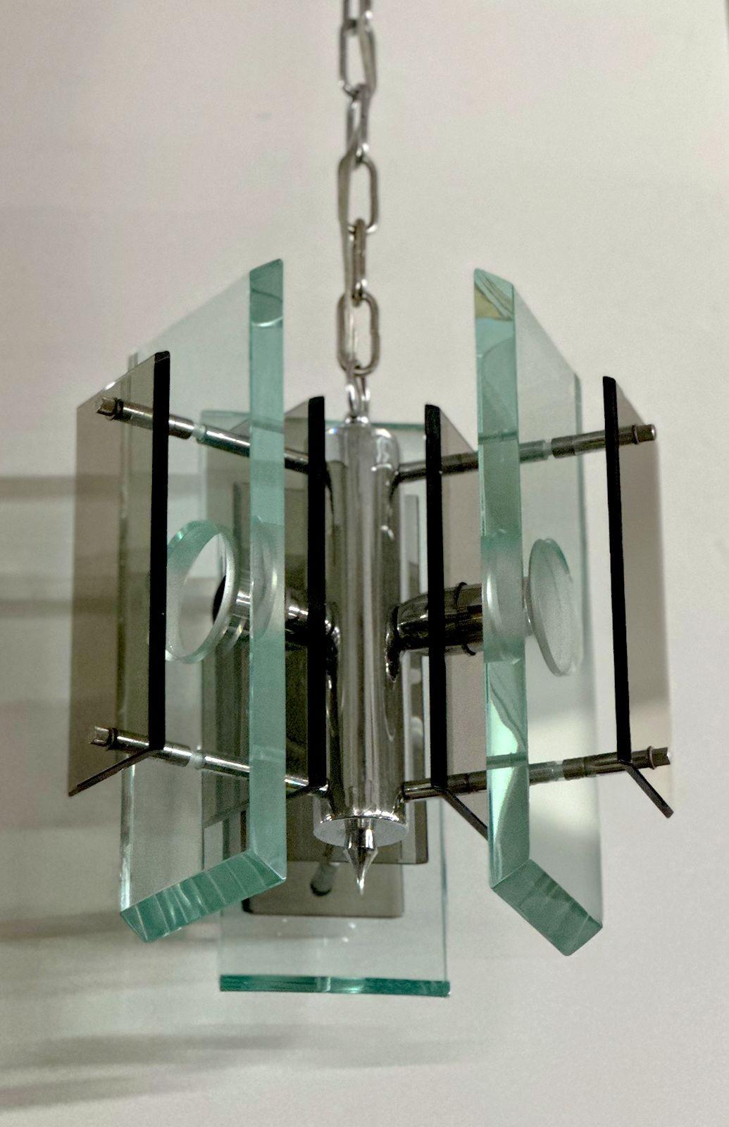 Beautiful vintage Italian pendant with clear and smoky Murano glass mounted on a chrome frame. Made in Italy, c. 1970's.
*Rewired to fit US lighting standards
*Chain can be adjusted to desired height.
Dimensions:
12