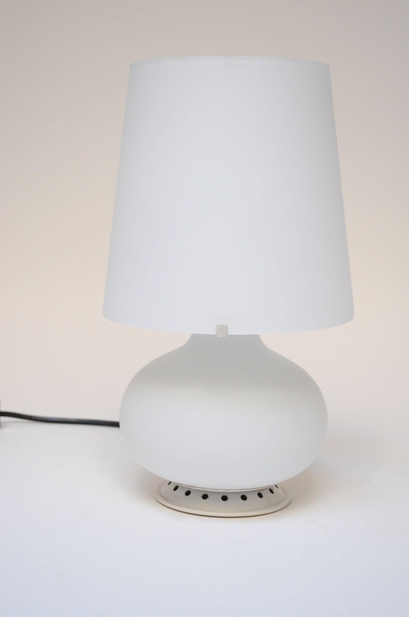 La versione più piccola dell'iconica lampada da tavolo in vetro smerigliato modello 1853, disegnata nel 1954 dal vetraio francese Max Ingrand per Fontana Arte.
Lampada elegante e pratica che occupa un ingombro ridotto ma emette una luce forte e