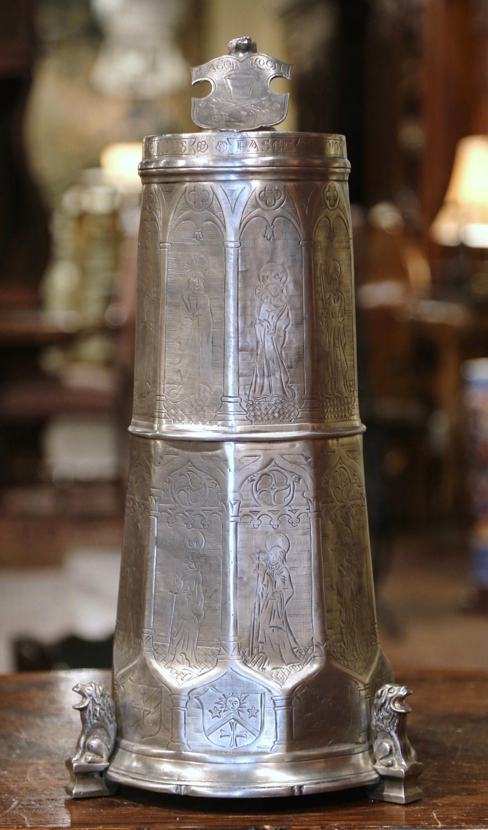 Decorate a wine cellar or a wet bar with this large beer mug. Crafted in Italy circa 2000 and made of pewter, the tall object stands on three lion shaped feet and features engraved decor throughout; it features a large handle on the side and the top