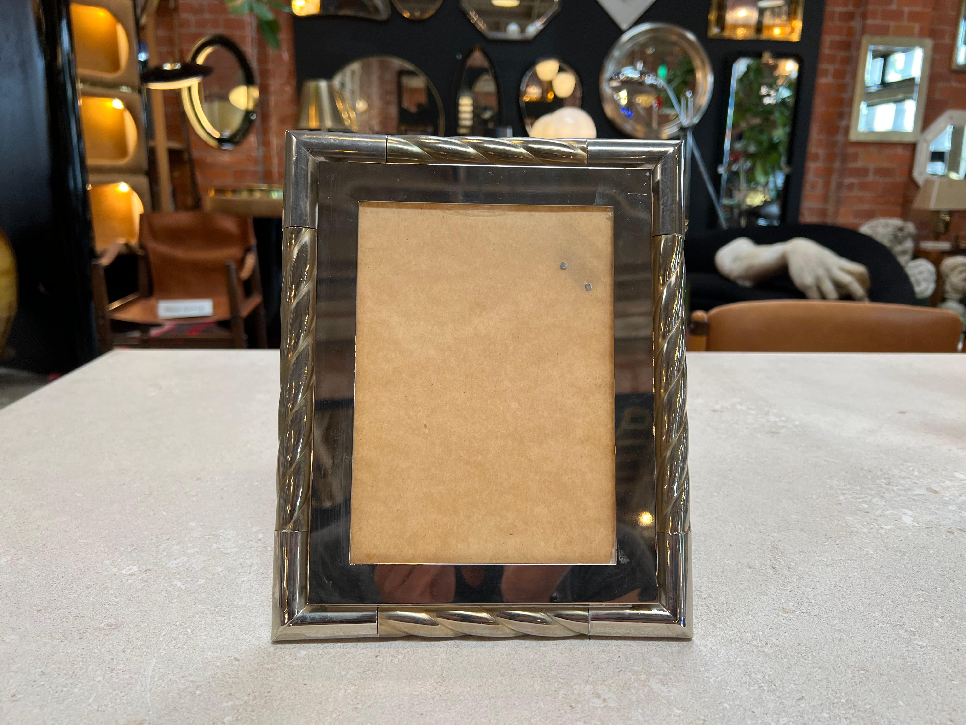 The Vintage Italian Picture Frame from the 1980s is a classic and elegant display piece that embodies the exquisite craftsmanship of Italian design. With its timeless appeal and refined aesthetics, this frame adds a touch of sophistication to