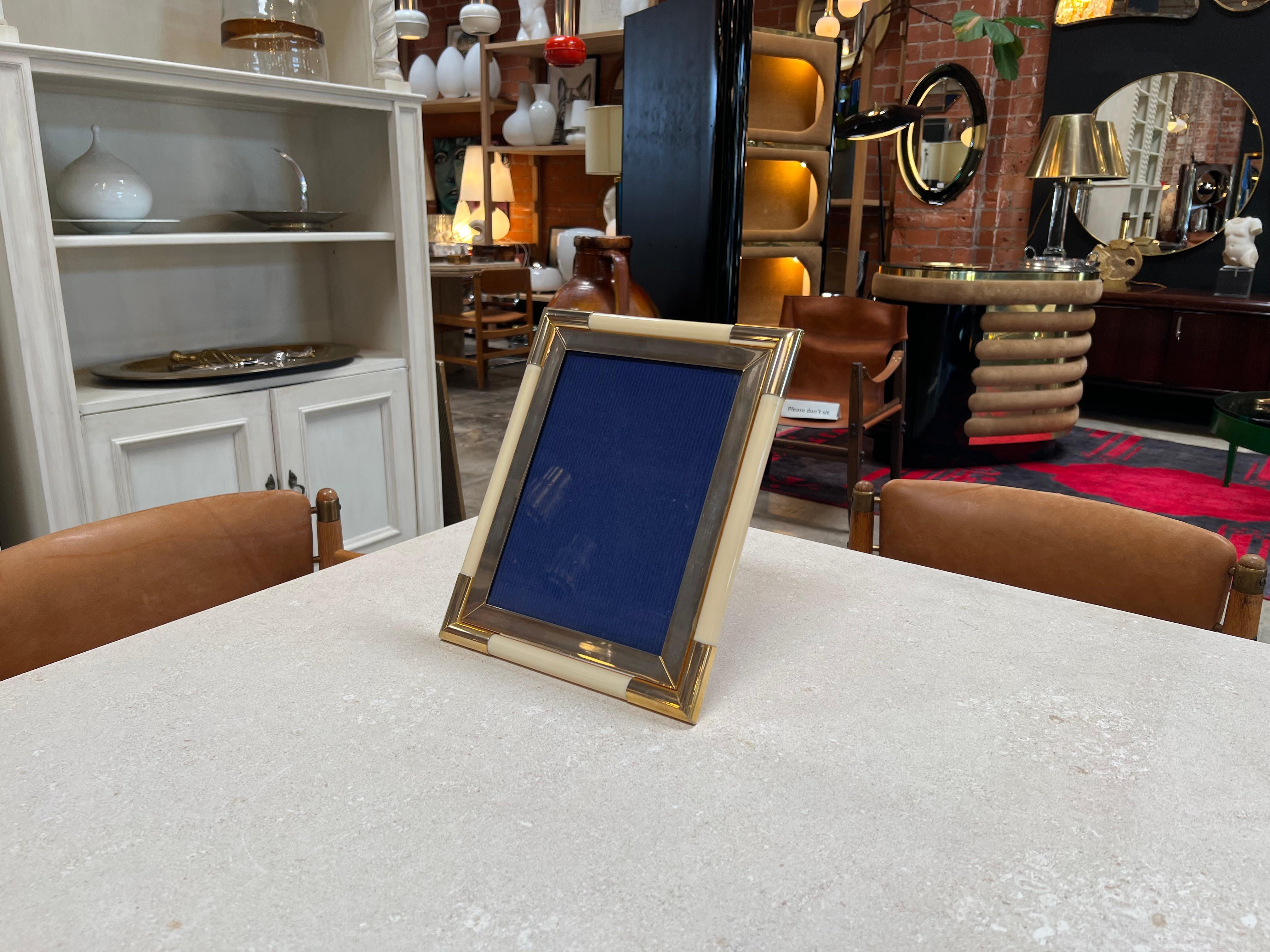 The Vintage Italian Picture Frame from the 1980s, featuring brass corners, is a charming and stylish photo frame hailing from Italy. Adorned with brass corners that add a touch of sophistication, this frame captures the essence of the era's design