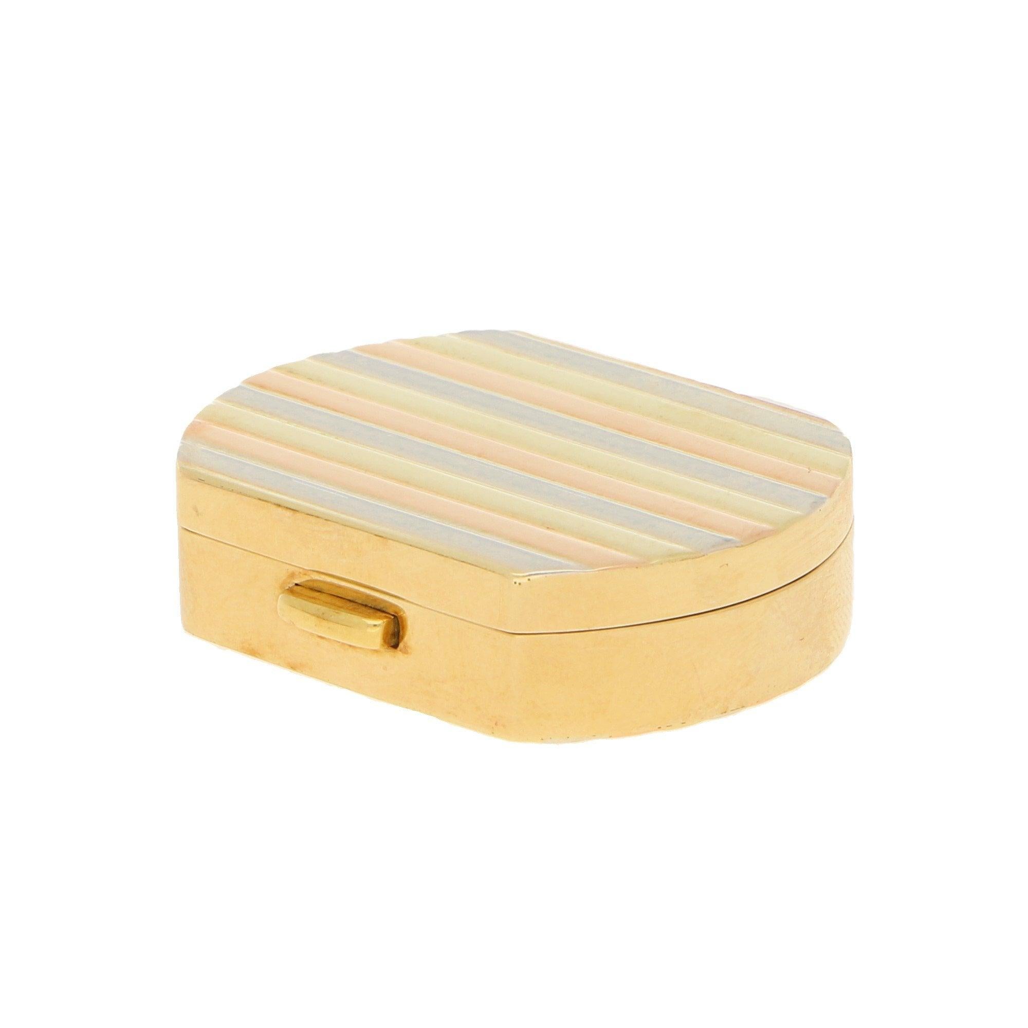 A vintage Italian pill box in 18-karat tricolour gold, circa 1990. This pill box of a cushion design features banded accents to the lid and base in a repeated pattern of alternating white, yellow and rose gold, the sides and aperture button in