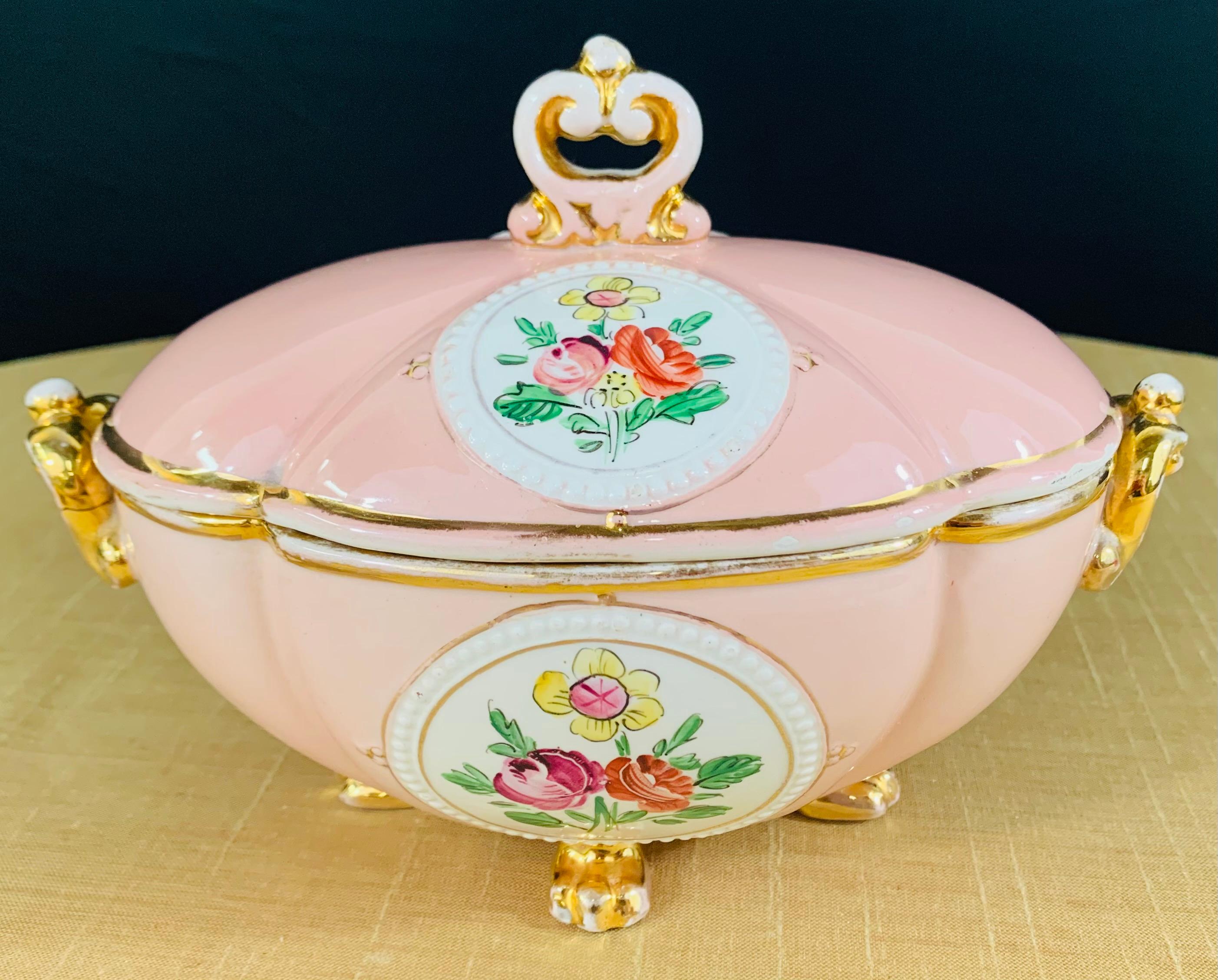 An exquisite and decorative Italian porcelain jewelry box. Hand painted in pink, gold and white with flower motifs, the jewlery box is signed in the bottom 