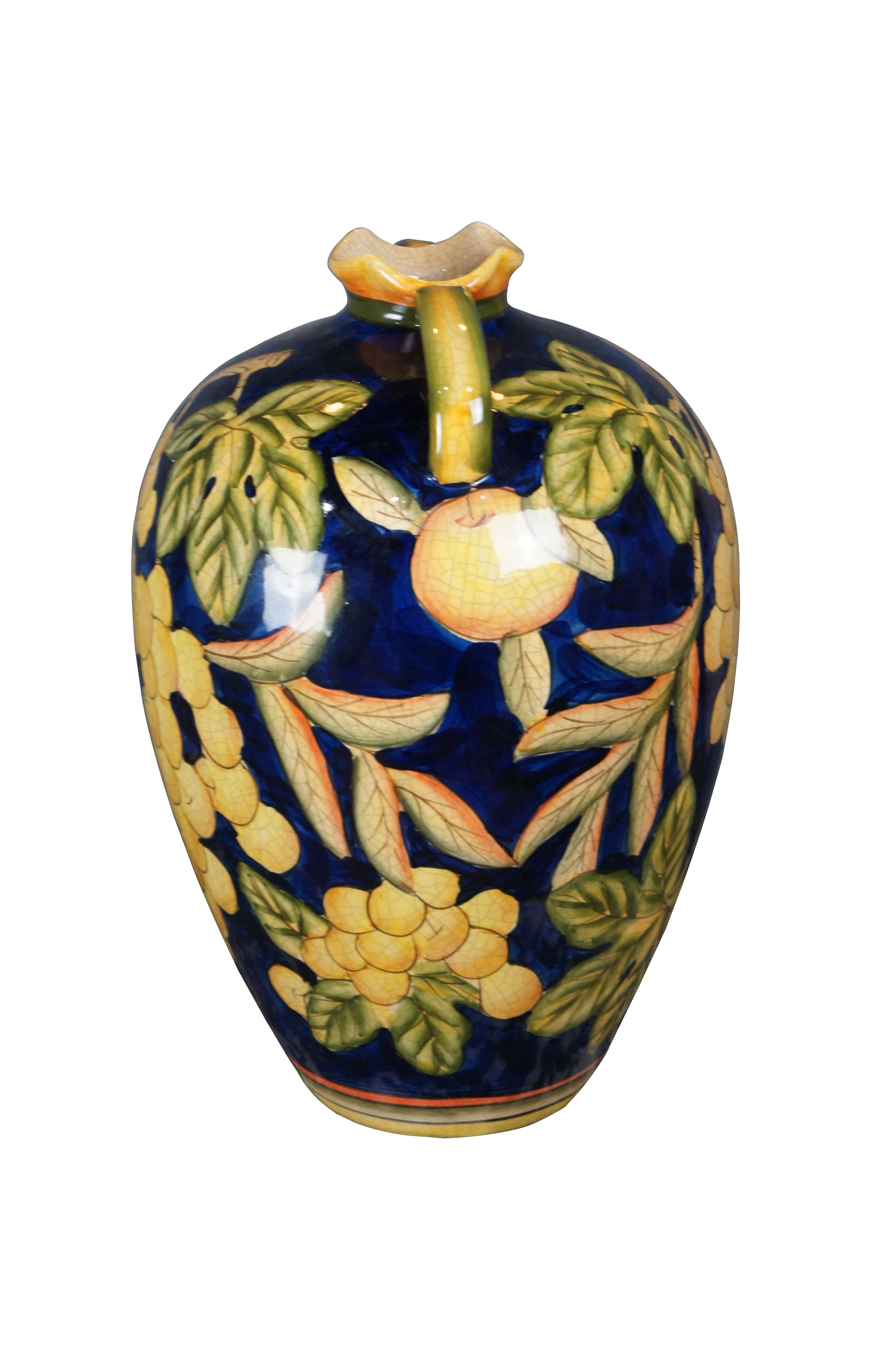 Late 20th century Italian porcelain polychrome handled wine jug. Features a grapevine motif in yellow, blue and green.

Dimensions:
9.5