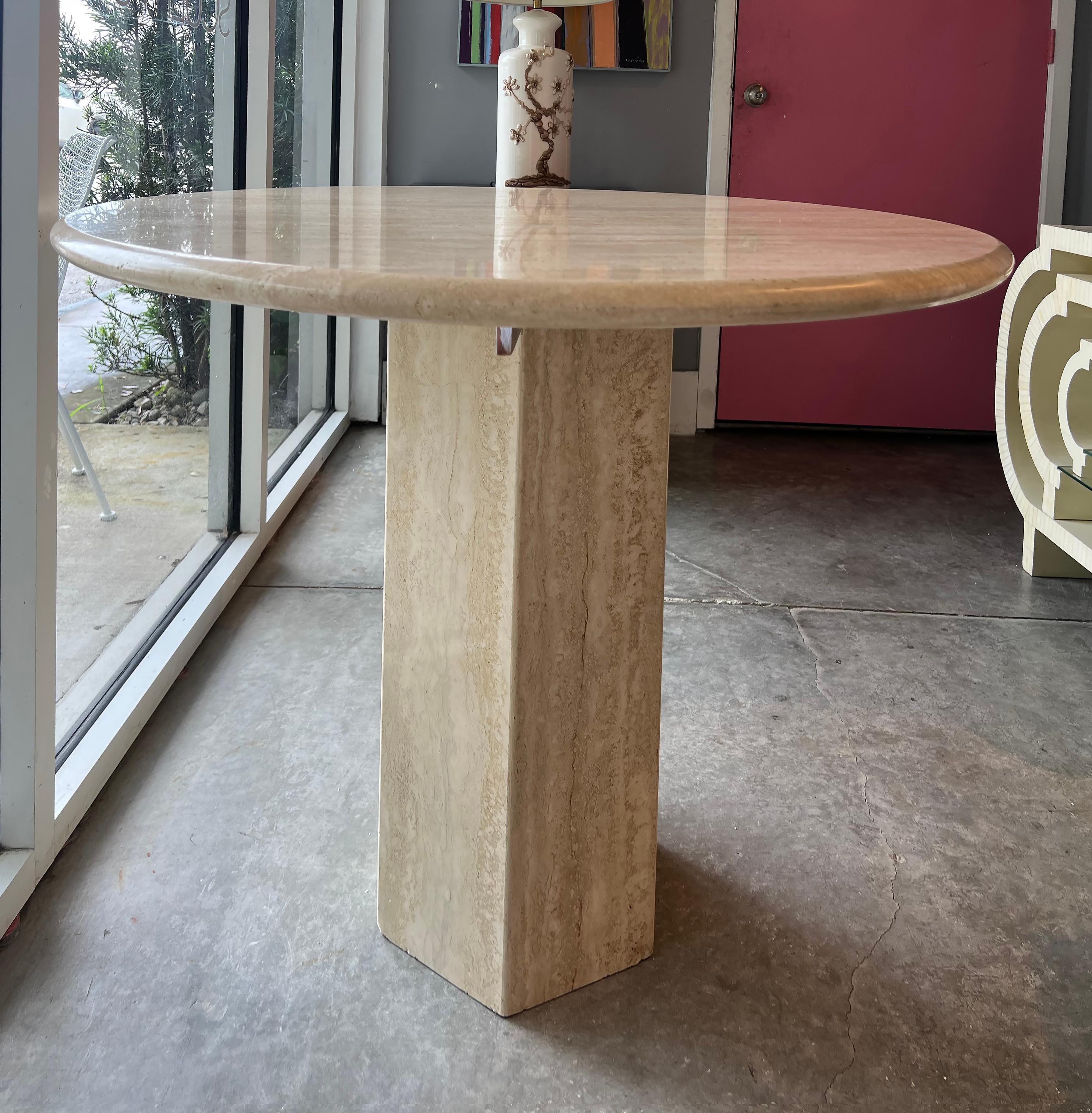 Vintage Italian post modern Polished Travertine Dining Table

Offered for sale is a substantial vintage Italian travertine dining table.  The round top is supported by crossed metal arms that are inset into the top of the base as commonly found in