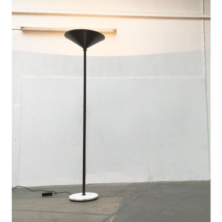 Italian floor lamp with marble base.

An impressive design of high-quality and heavy materiality. The long shaft is composed of radially arranged rods. Above it widens into a large funnel. Below it ends in a round base of marble. The lamp is browned
