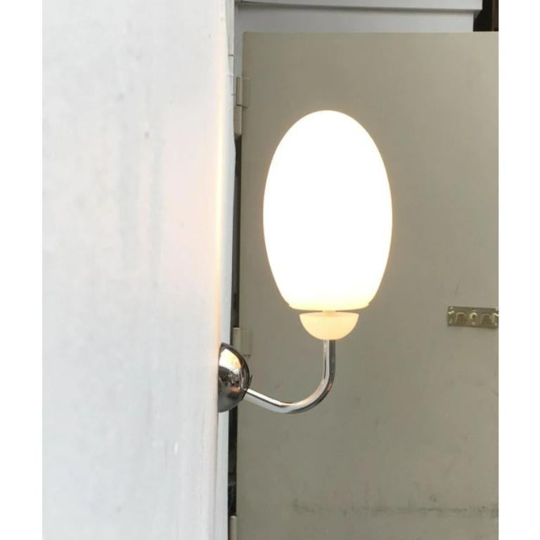 Die brera w ist die Wandleuchtenversion aus der brera-Serie von Flos nach einem Entwurf von Achille Castiglioni.

eine schlichte und elegante Wandleuchte aus Glas und Chrom. Der eiförmige Leuchtenkörper aus Opalglas sitzt auf einem geschwungenen Arm