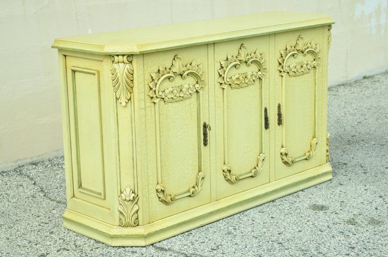 Vintage Italian French provincial style yellow and green distress painted buffet server cabinet. Item features yellow distress painted finish, green painted trim, nicely carved details, 3 swing doors, working lock and key, great style and form.
