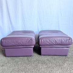 Vintage Italian Purple Leather Ottomans on Castors - A Pair