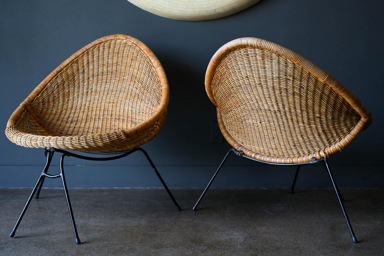 Vintage Italian Rattan and iron scoop chairs and table, ca. 1950. Beautiful and unique teardrop chair design with original frames, feet and rattan in good vintage condition. From prominent estate in Southern California, family lived in Italy and