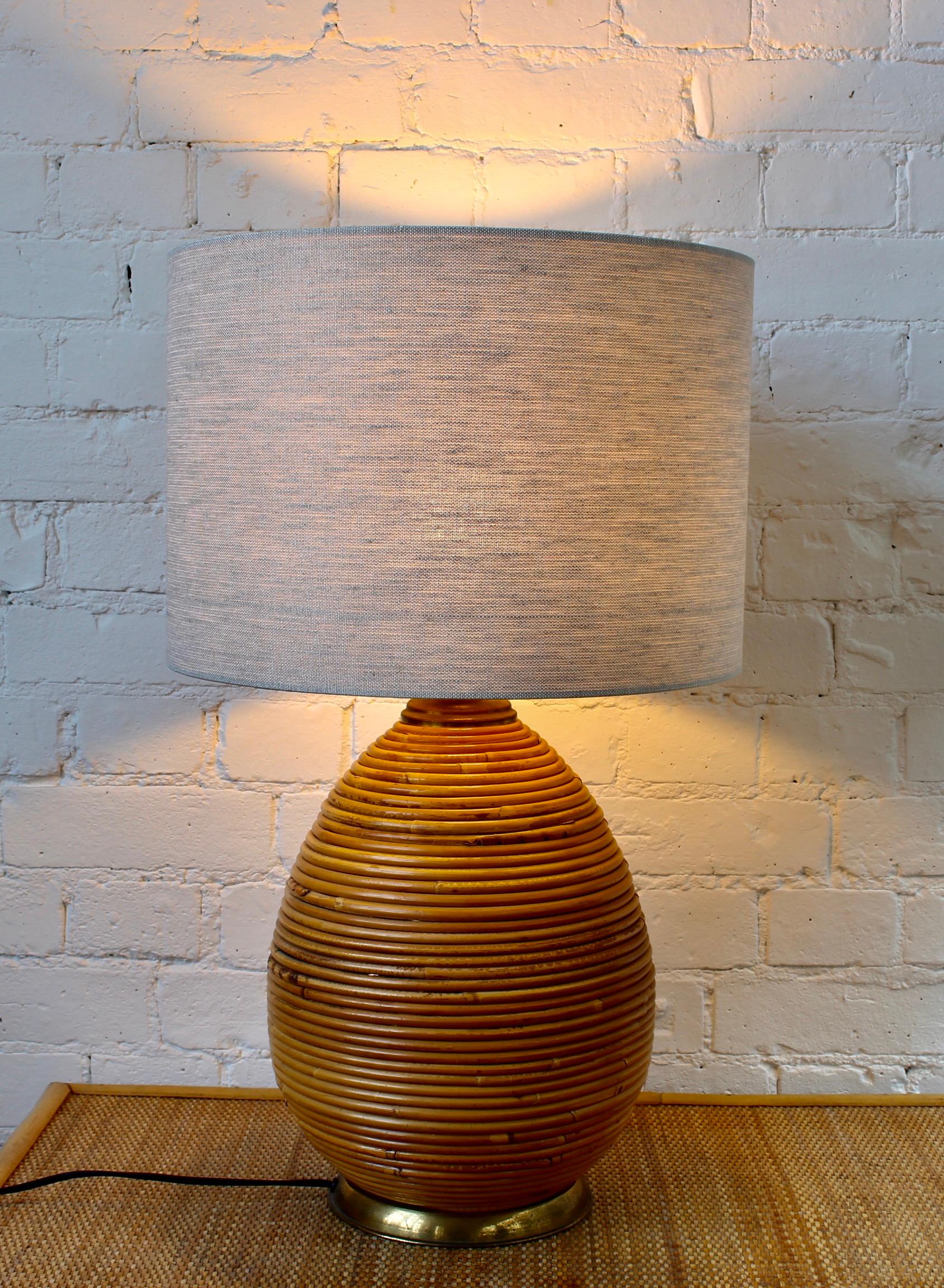 Vintage Italian rattan table lamp attributed to Vivai del Sud (circa 1970s). Stunning cane reeds of circular rattan which rise in concentric circles from a brass-finish base. It transports one immediately to the sun and sand of the Italian Riviera.