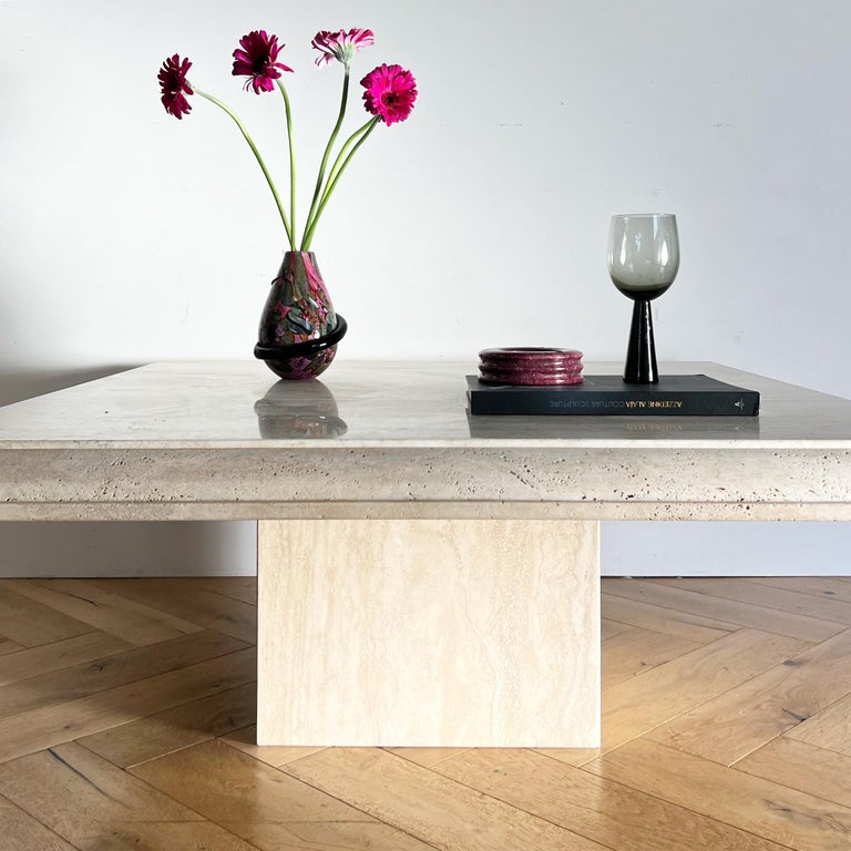 A vintage Italian raw travertine coffee / center table, made in Italy circa late 1970s. Featuring a pedestal base and thick bullnose edge, this statement table showcases the glorious beauty of travertine stone in its raw form. D’après the postmodern
