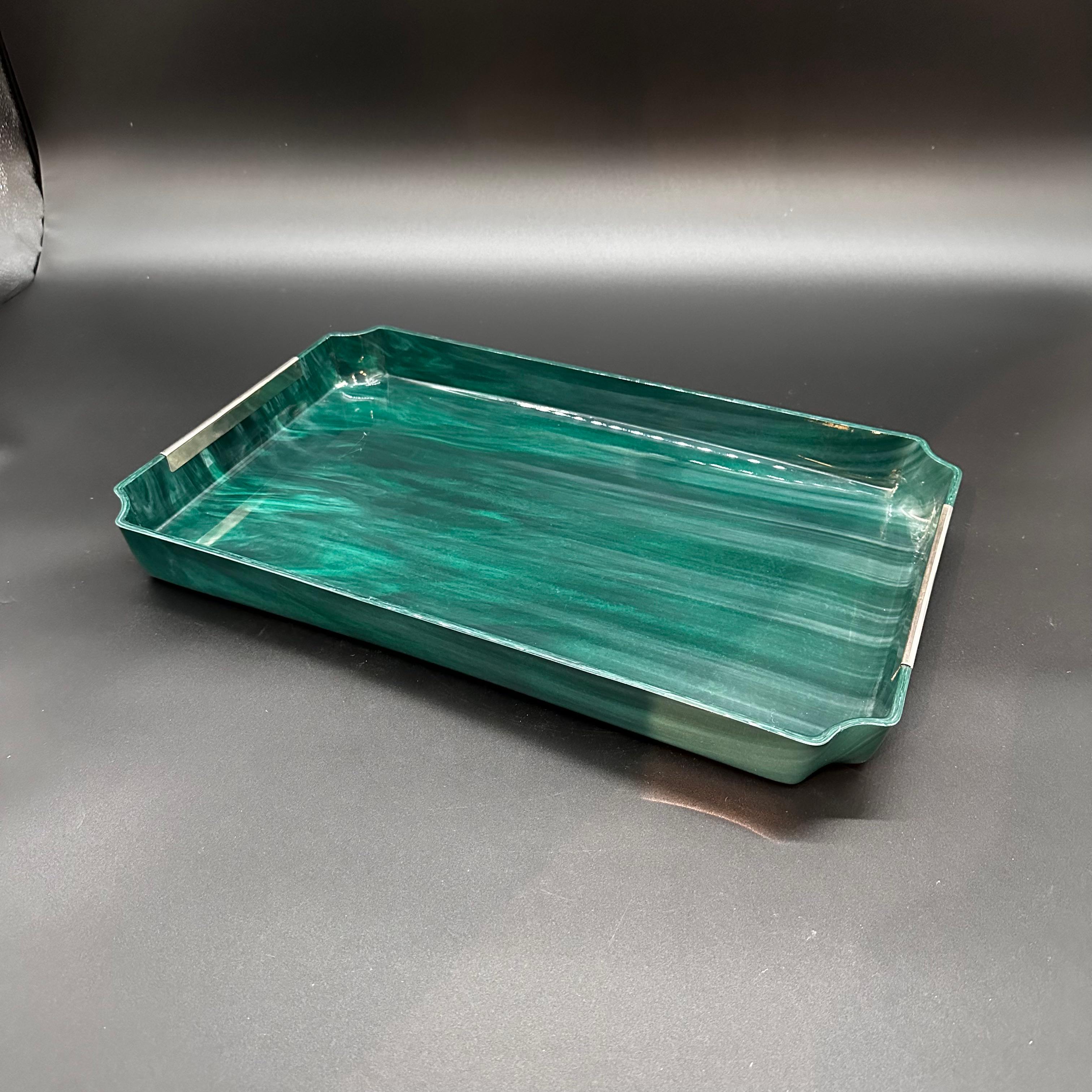 The Vintage Italian Rectangular Blue Tray from the 1980s is a stylish and elegant piece characterized by its sleek design and vibrant blue color. Crafted in Italy during the 1980s, this tray typically features clean lines and a glossy finish, making