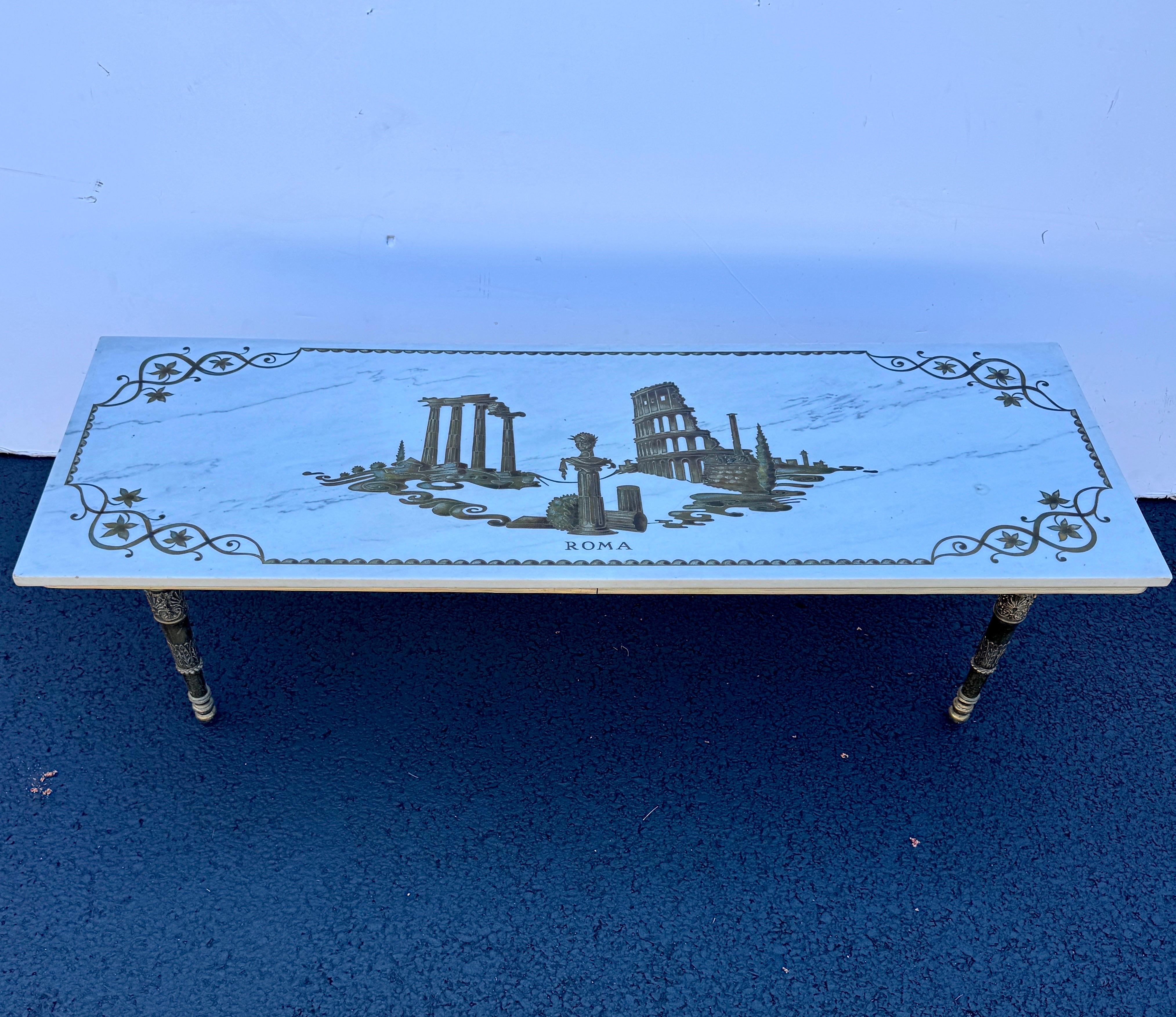 Impressive long rectangular Italian sculptural marble coffee table featuring brass trim and brass plated tapered legs from the Mid-20th Century. The top service has an engraved scenery of Italian ruins and the city name of Rome. Certainly makes a