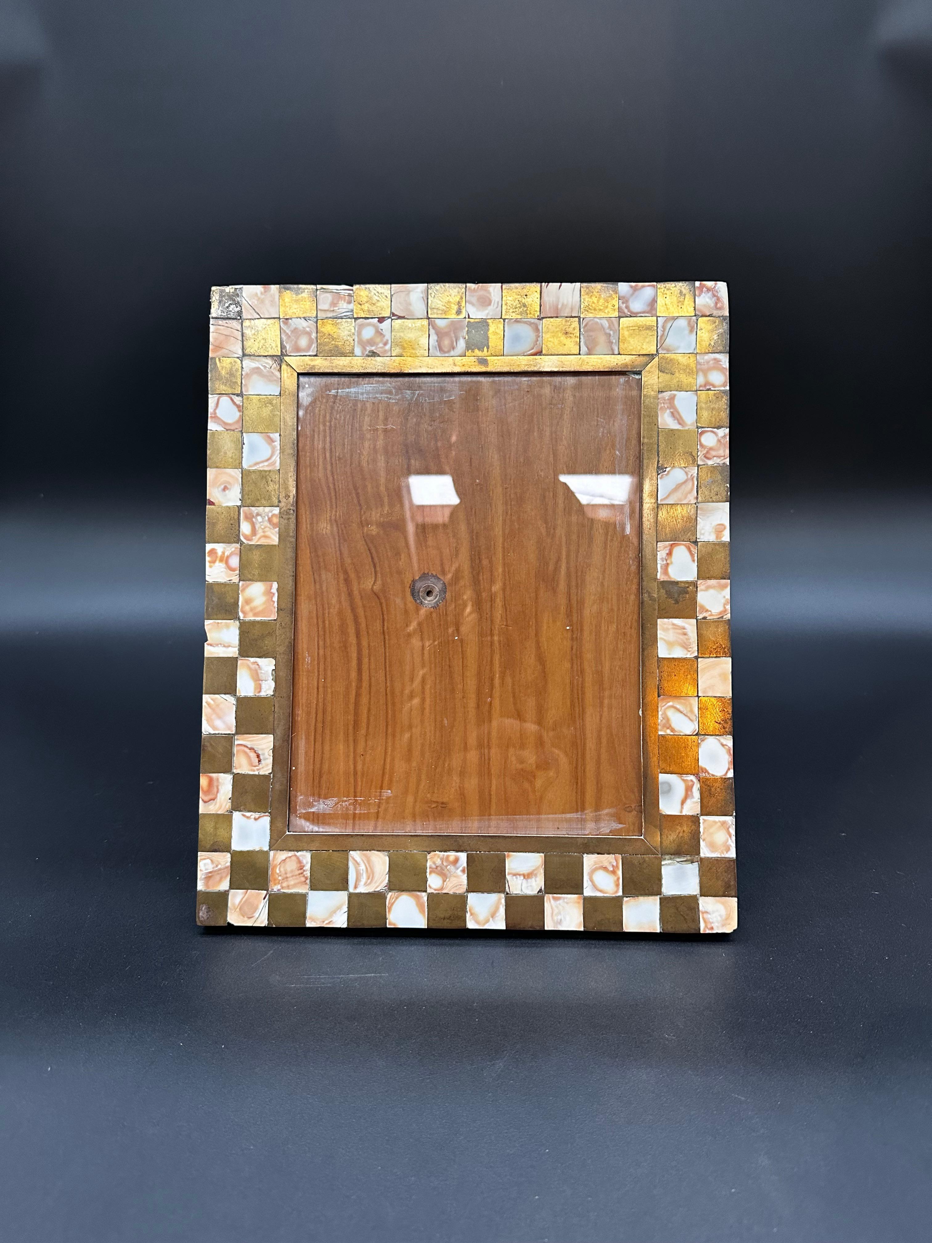 The Vintage Italian Rectangular Picture Frame from the 1970s is a classic piece of Italian craftsmanship. Featuring clean lines and understated elegance, this frame is crafted from high-quality materials, likely wood or metal, with a sophisticated
