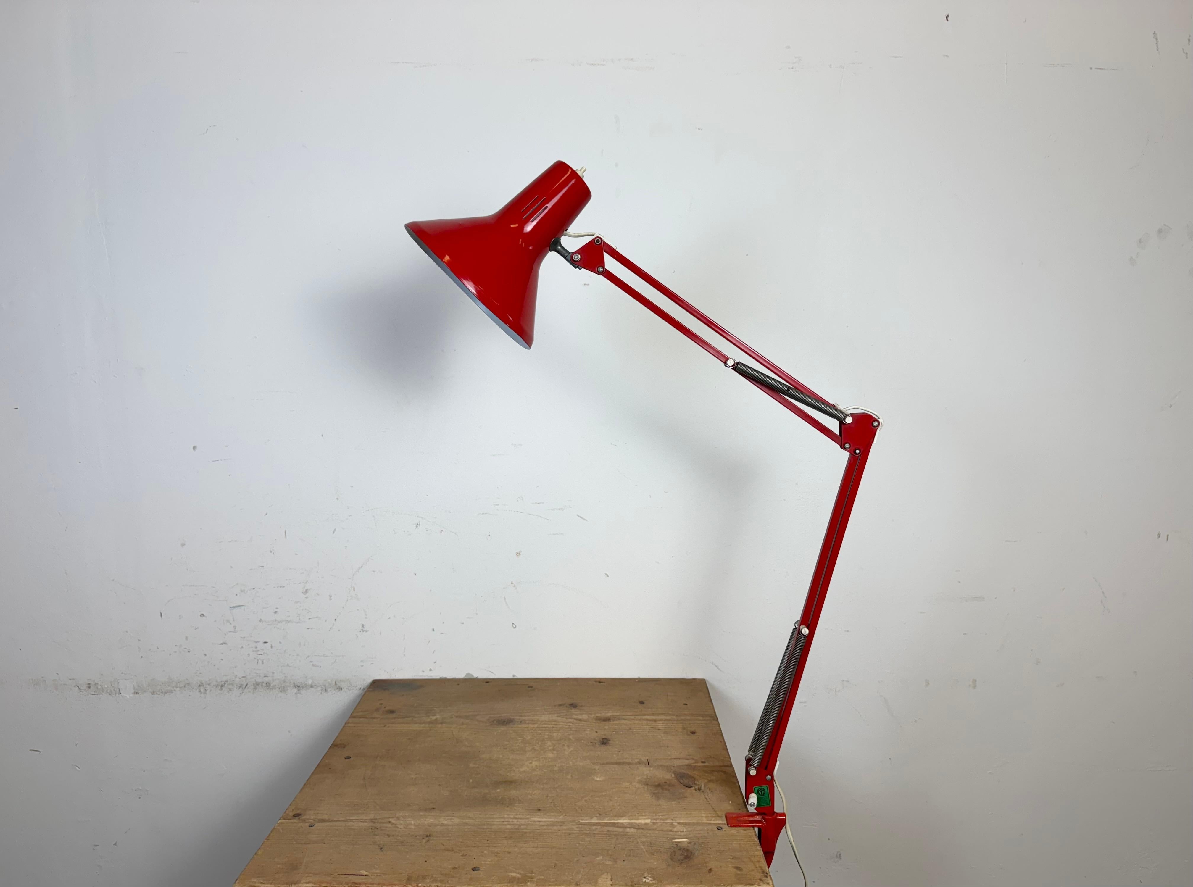 Vintage red adjustable table lamp made in Italy during the 1970. Adjustable in all desired positions. It features an aluminium shade and an iron arm with clamp base. The socket requires standard E 27/ E 26 light bulbs. The diameter of the shade is