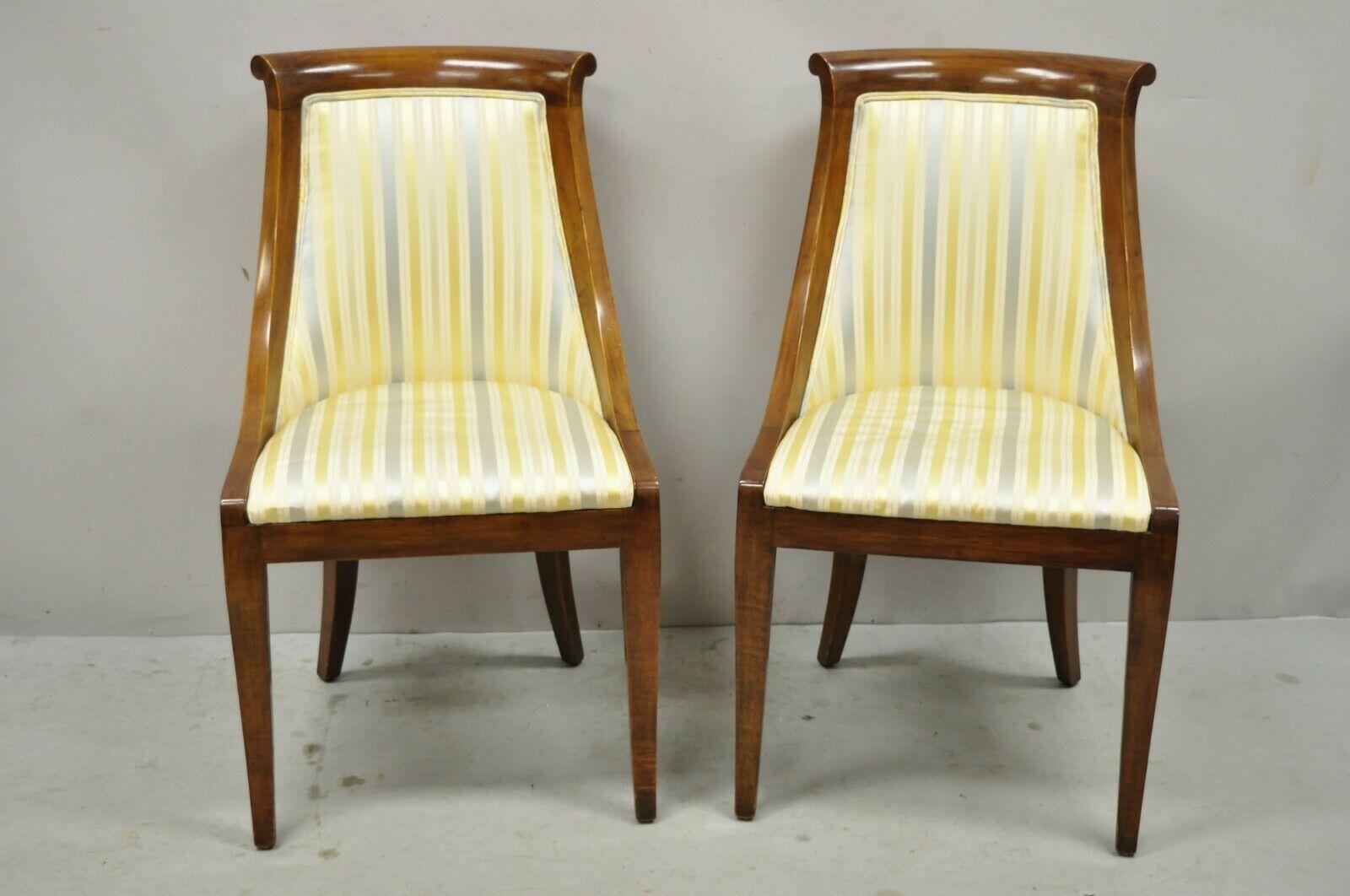 Vintage Italian Regency cherry wood saber leg dining side chairs - a pair. Chairs feature solid wood frames, beautiful wood grain, distressed finish, shapely saber legs, quality craftsmanship, great style and form. Circa Mid 20th Century.